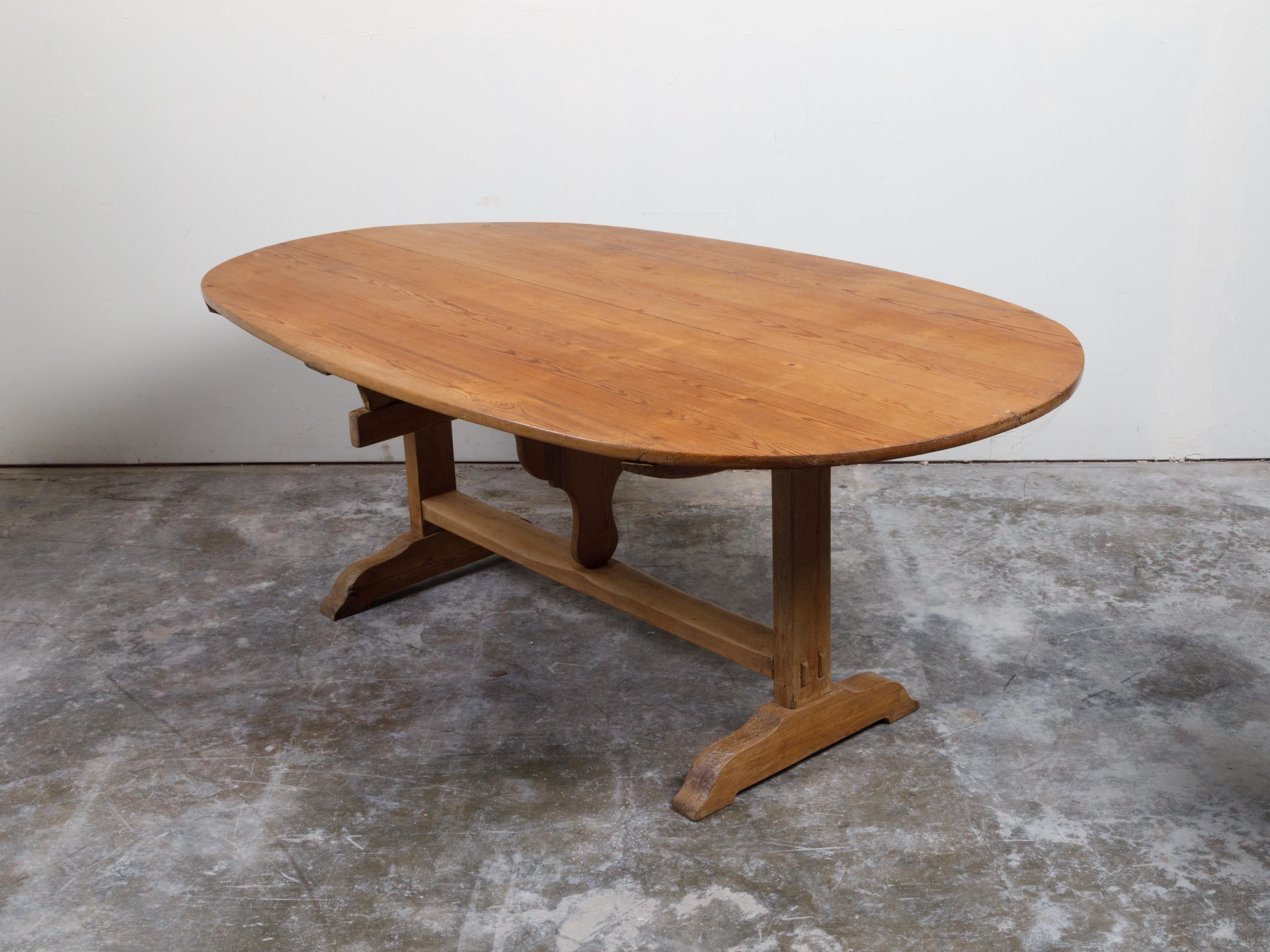 French 19th Century Rustic Walnut Farm Table with Oval Tilt Top and Trestle Base 7