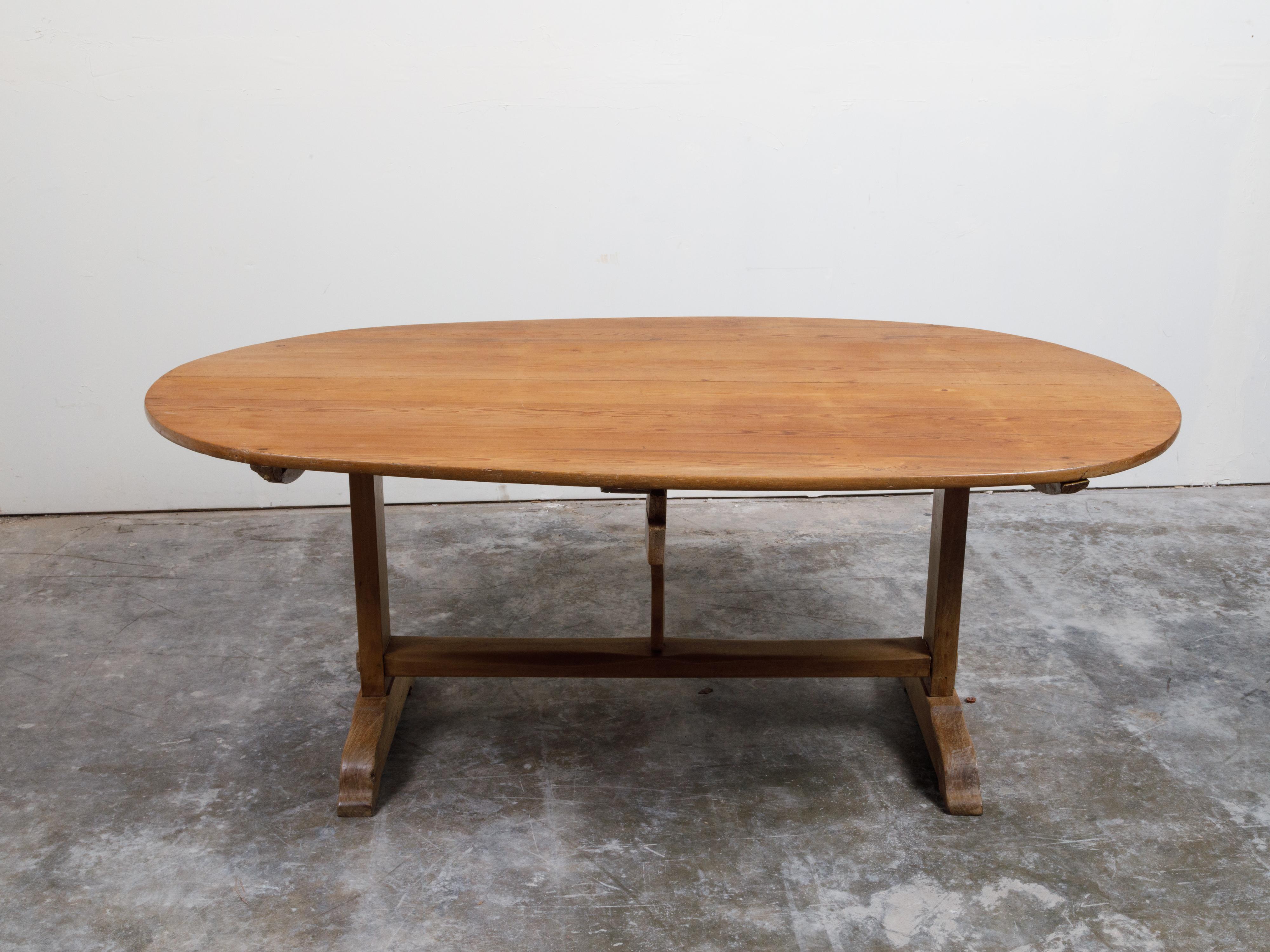 French 19th Century Rustic Walnut Farm Table with Oval Tilt Top and Trestle Base 8
