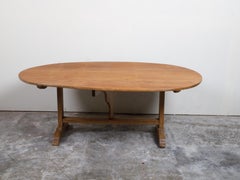 French 19th Century Rustic Walnut Farm Table with Oval Tilt Top and Trestle Base