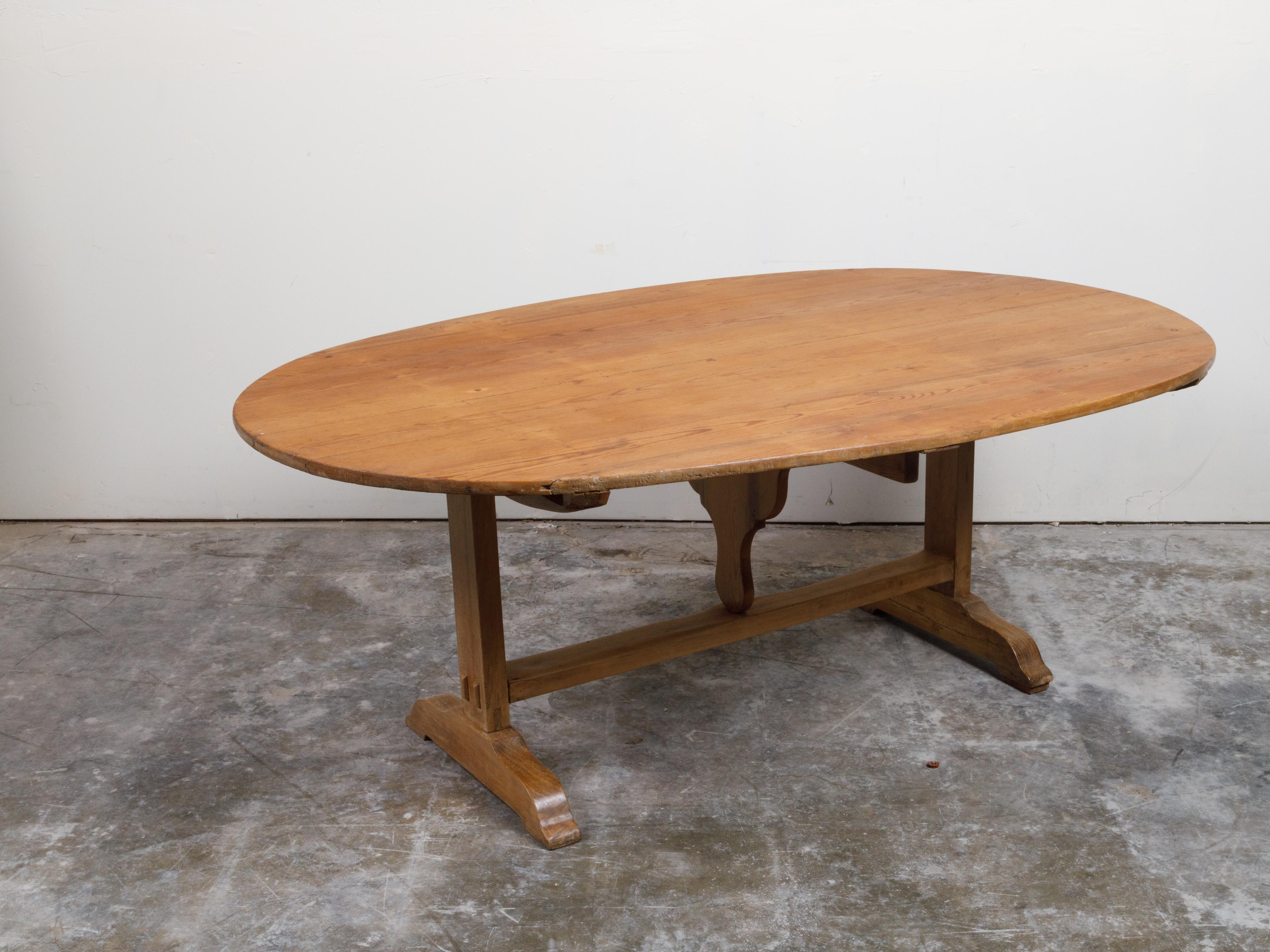 French 19th Century Rustic Walnut Farm Table with Oval Tilt Top and Trestle Base 4