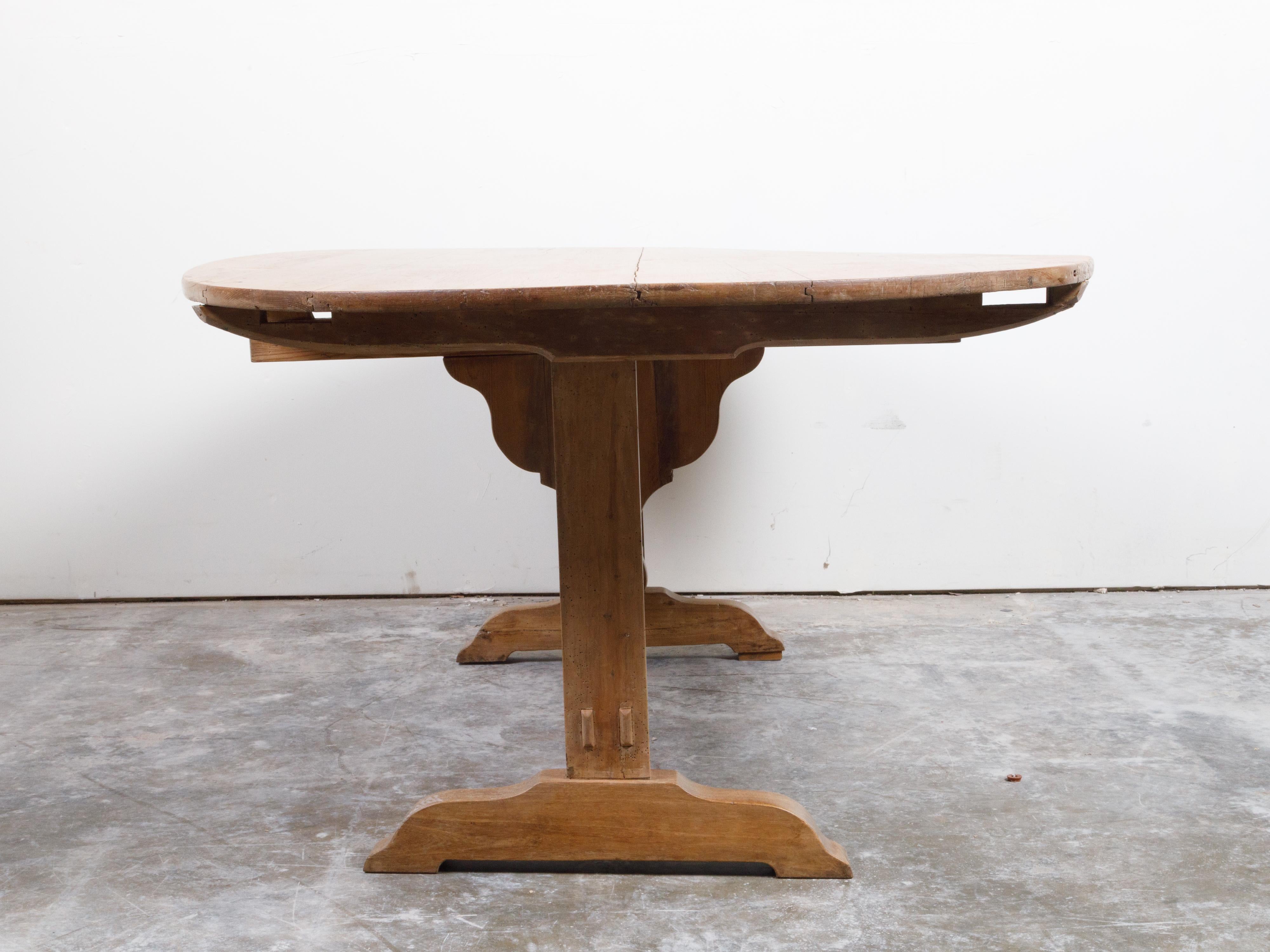 French 19th Century Rustic Walnut Farm Table with Oval Tilt Top and Trestle Base 6