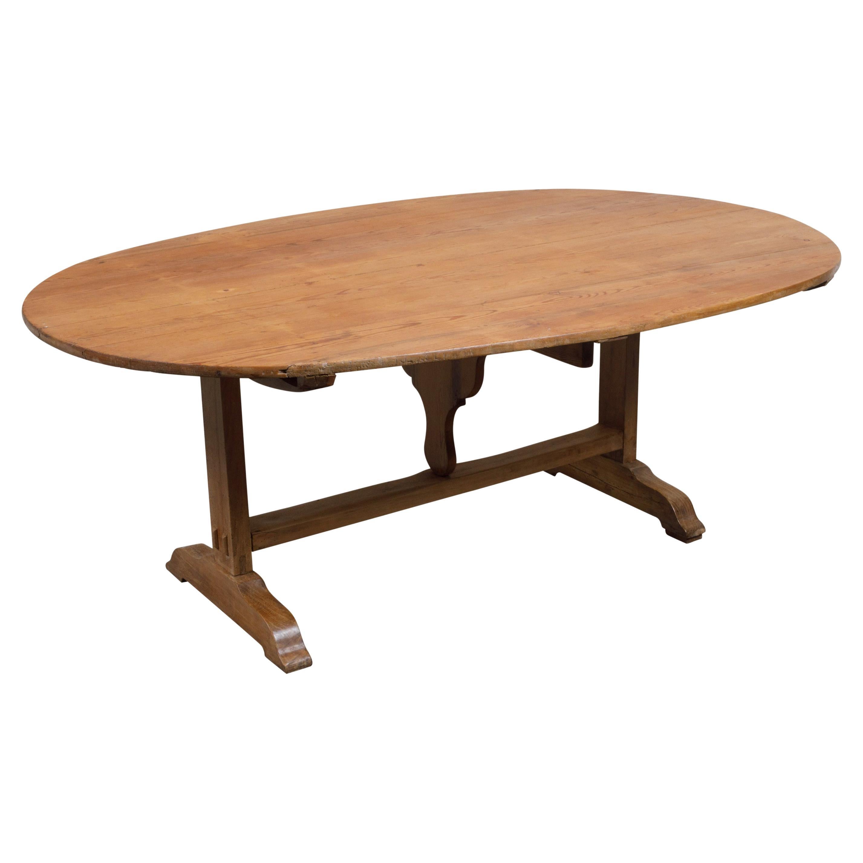 French 19th Century Rustic Walnut Farm Table with Oval Tilt Top and Trestle Base