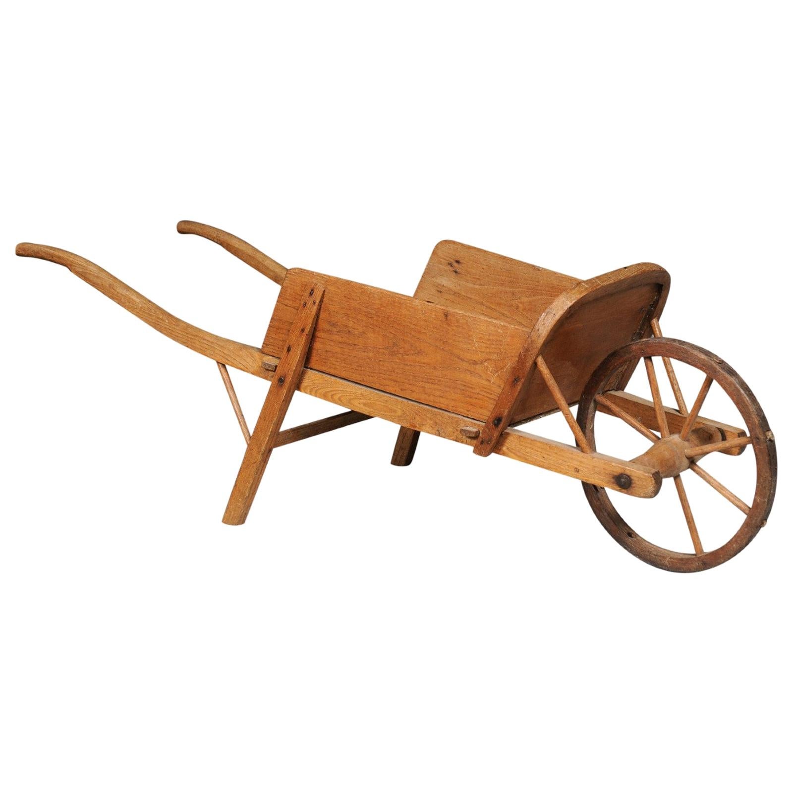 French 19th Century Rustic Wooden Child's Wheelbarrow with Curving Handles