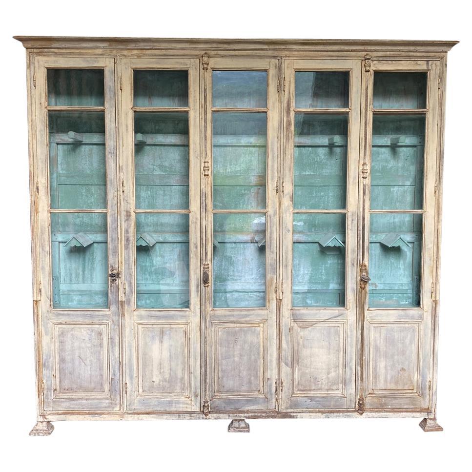 An exceptional late 19th century Saddle Display Case in Bibliotheque form from a horse farm in the Southwest of France.  Soundly constructed from painted wood with original glass.  This sensational piece was used to house jockey saddles and other