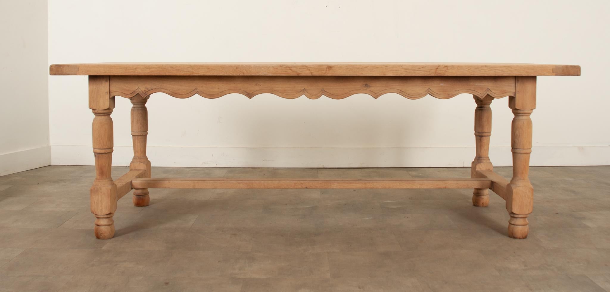 This fantastic solid oak dining table has a unique scrubbed finish that makes it unlike many other antique tables on the market. This 19th century quarter-sawn French oak dining table has had its finish removed, leaving a raw surface which is both