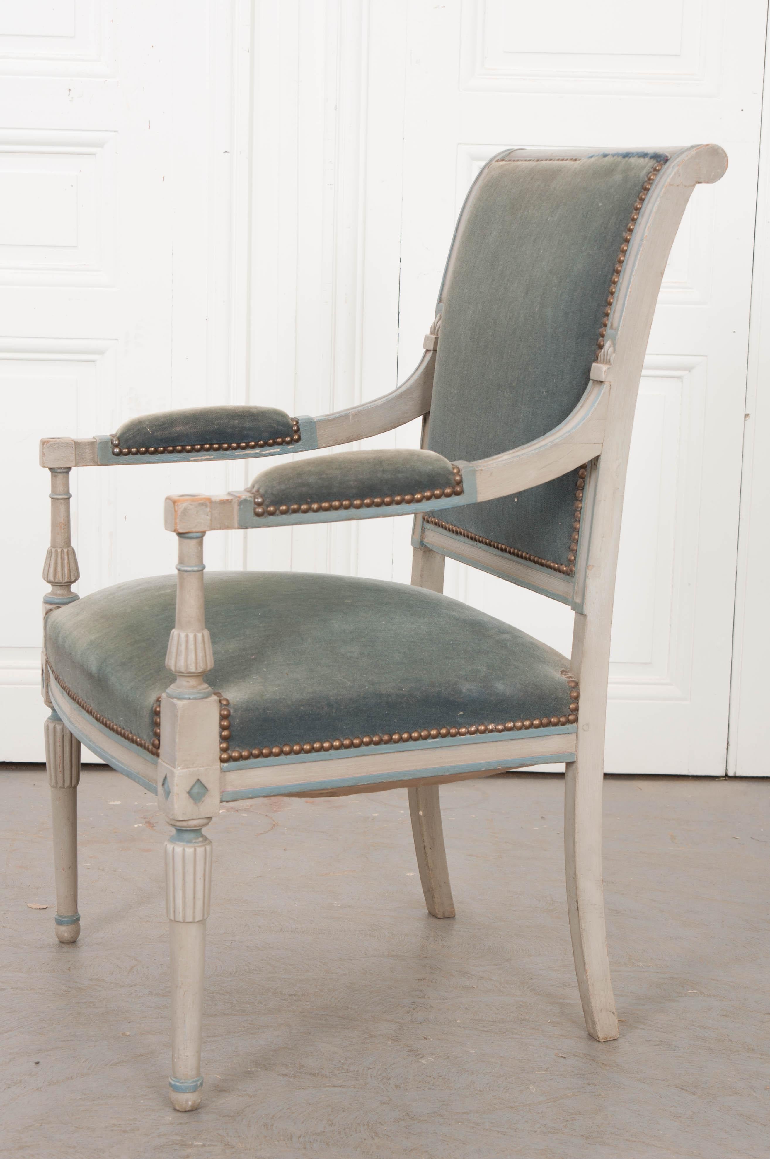 This delightful Second Empire carved and painted fauteuil, circa 1870 is from France. The frame is painted grey with pale French-blue highlights and retains the original slate-blue velvet upholstery. This armchair would make a great fauteuil de