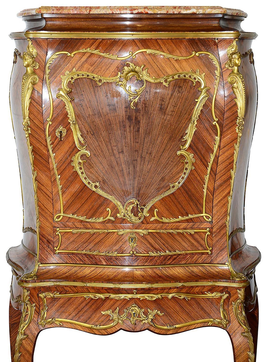 A fine quality late 19th Century French Kingwood Bombe shaped Secretaire Abbatant, having the original Rouge serpentine marble top, wonderful gilded ormolu mounts. The fall opening to reveal a compartmented interior, a single drawer beneath and 