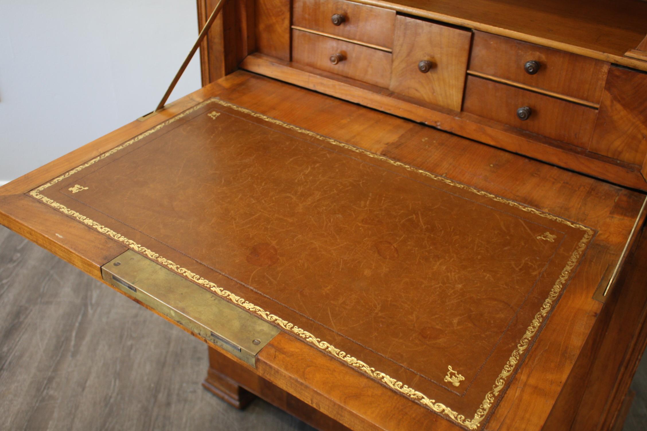 This Louis-Philippe Secretaire Desk is made of blond flamed mahogany with a Sainte-Anne marble top with a lot of drawers.