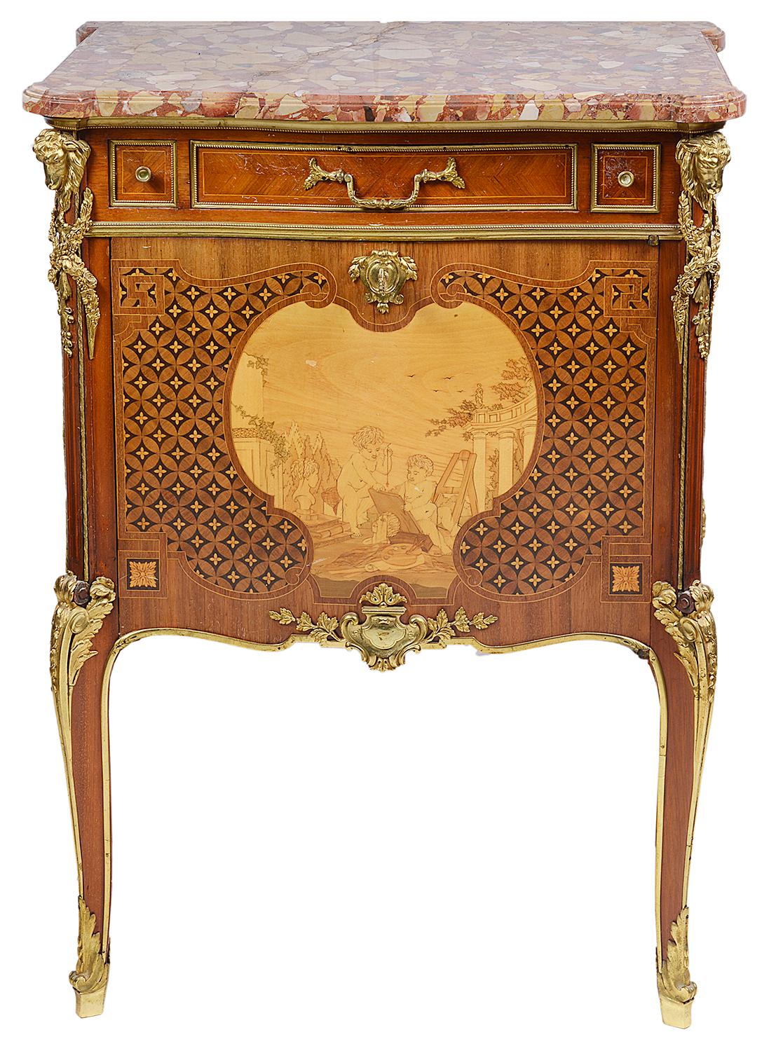 A fine quality late 19th century French Louis XVI style marble topped side cabinet. Having wonderful quality gilded ormolu mounts depicting swags, drapes and buffalo heads. Parquetry and marquetry inlaid decoration to the sides and front, which