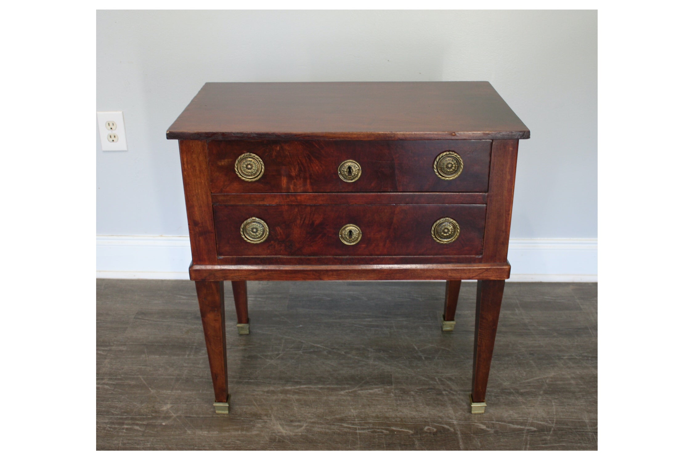 This Louis XVI style chest is small and made of flamed mahogany.