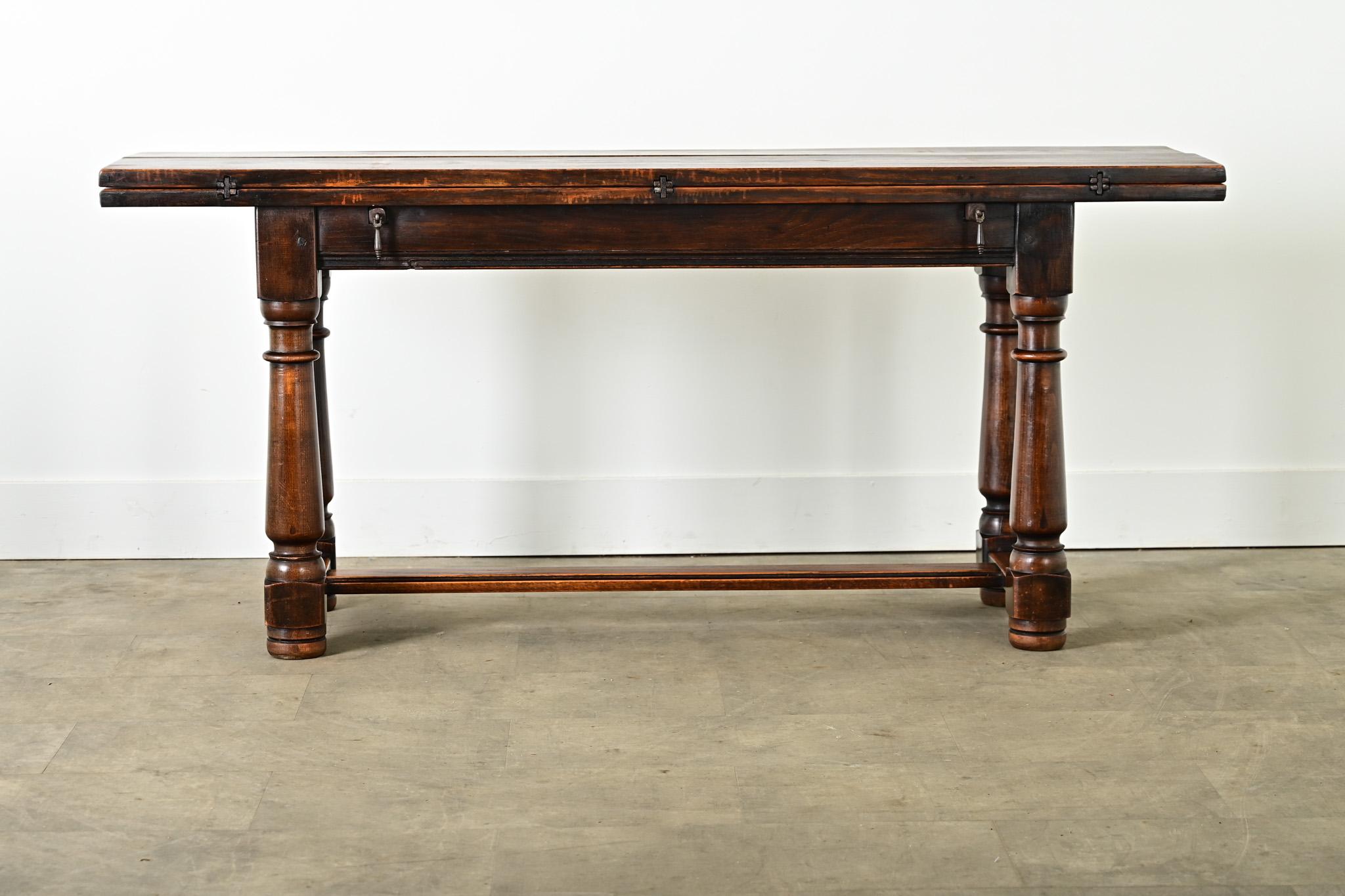 A rare, metamorphic oak table from 18th century France, appearing to be a substantial console table that easily flips open–nearly doubling in depth–to use as an occasional serving table, center table, or for dining. The handmade solid oak