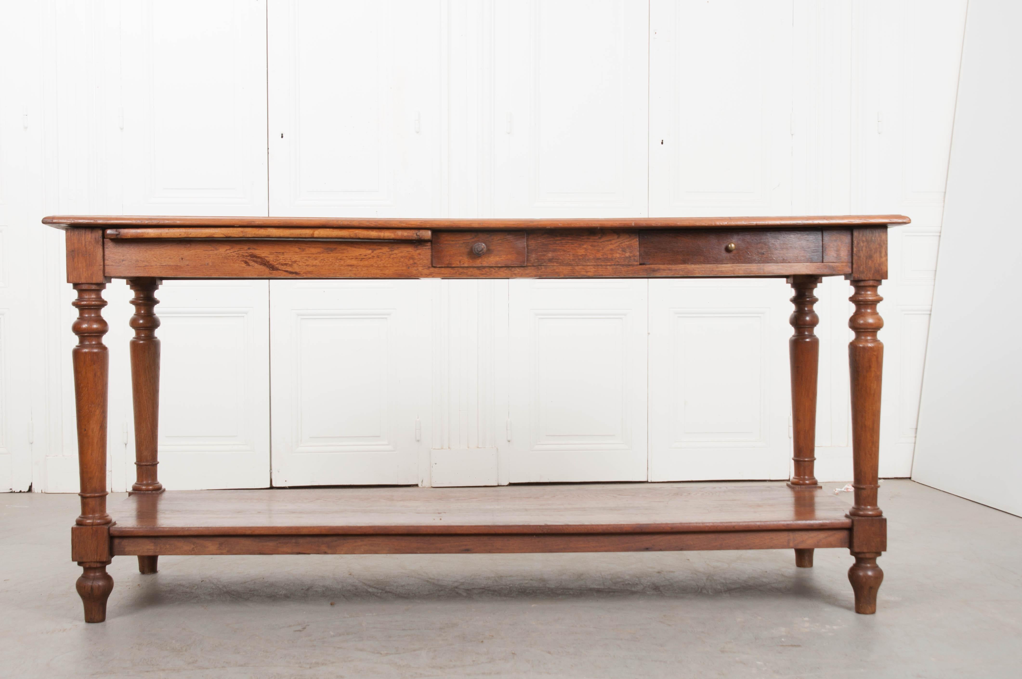 Beautiful, long graining enrich the already lustrous oak surface of this amazing French drapers table. Originally used by tailors and seamstresses, these lengthy tables would provide a work surface long enough for yards of fabric to be laid out and