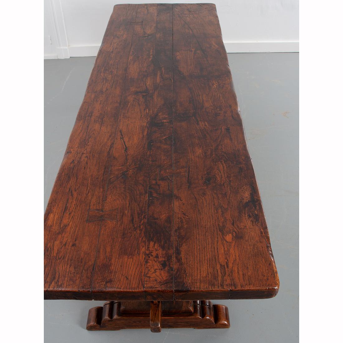 Large slabs of solid oak were used to create this stunning, French oak trestle table. The primitive, 2-½” thick oak has achieved a remarkable patina over the course of its lifetime. Two shapely vertical supports are joined by a stretcher below the