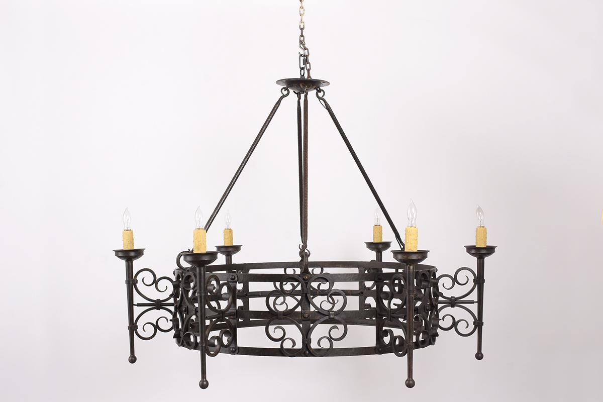 A late 19th century French forged wrought iron six lights chandelier is in good condition and has a beautiful aged patina finish. The wrought iron chandelier was handcrafted and has beautiful details along with the chandelier. This iron chandelier