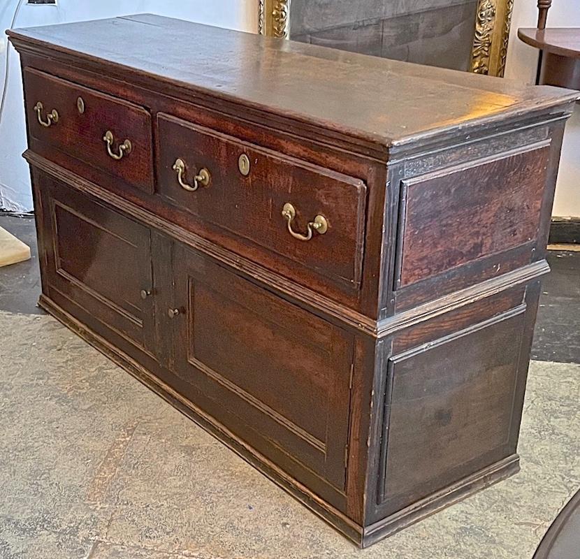 This is an unusual French 19th century walnut buffet as it has not only 2 lower doors which open to a storage compartment it also has 2 large upper drawers.