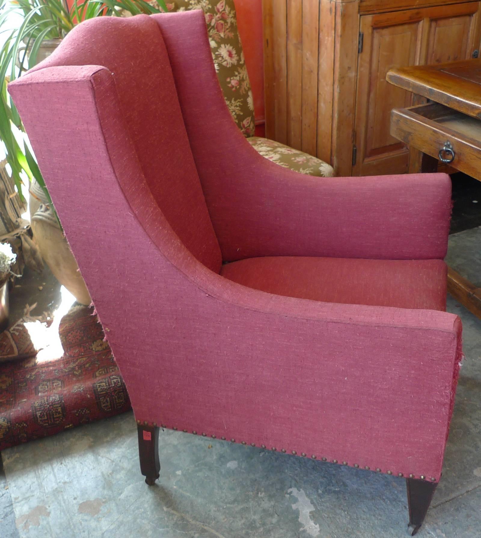 French 19th Century Stained Walnut Wing Backed Armchair on Four Castors. Sold as is.