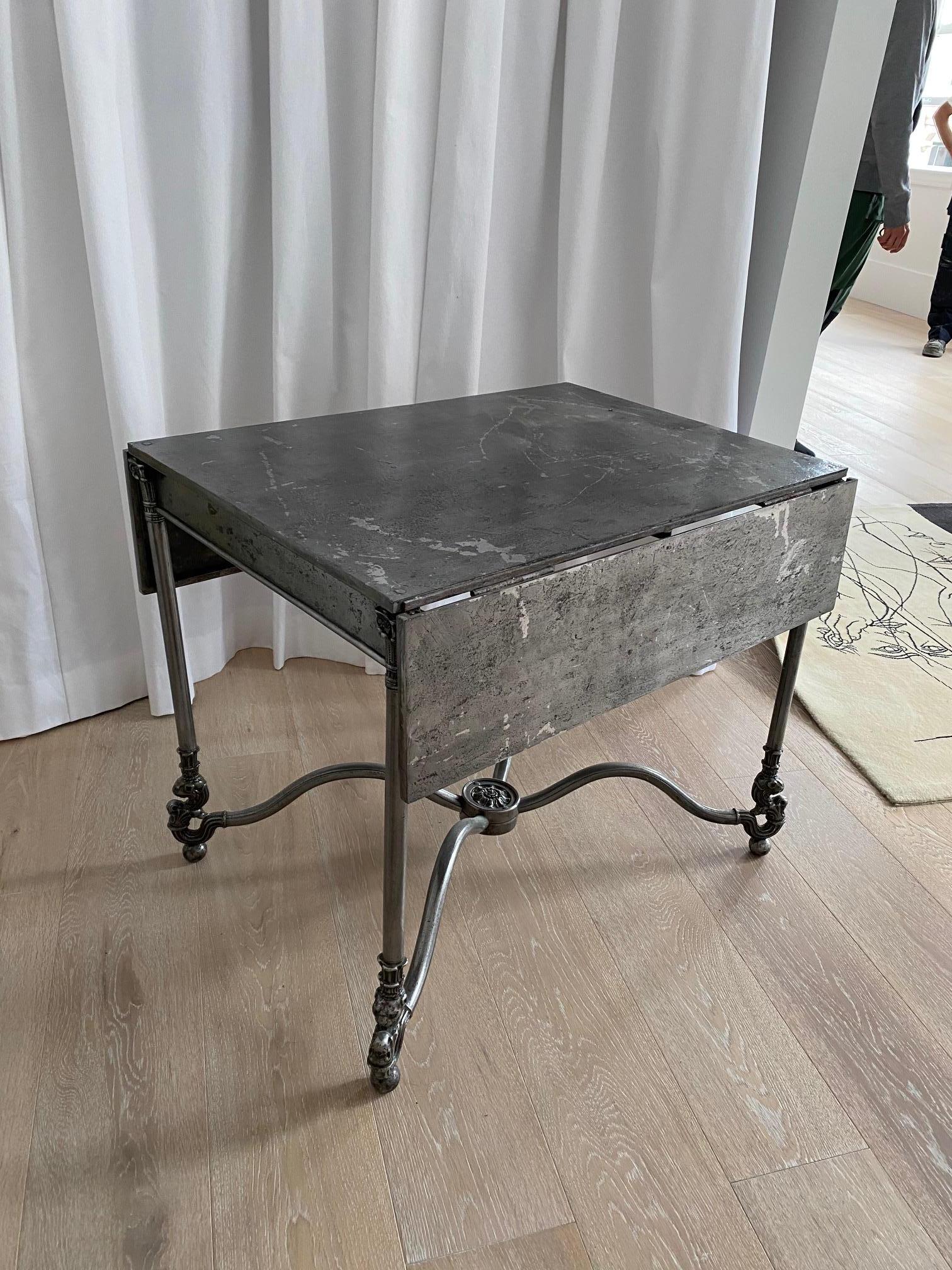 French 19th century steel folding table decorated with Corinthian legs and scroll feet when open at full extension the length is 37.5 in.