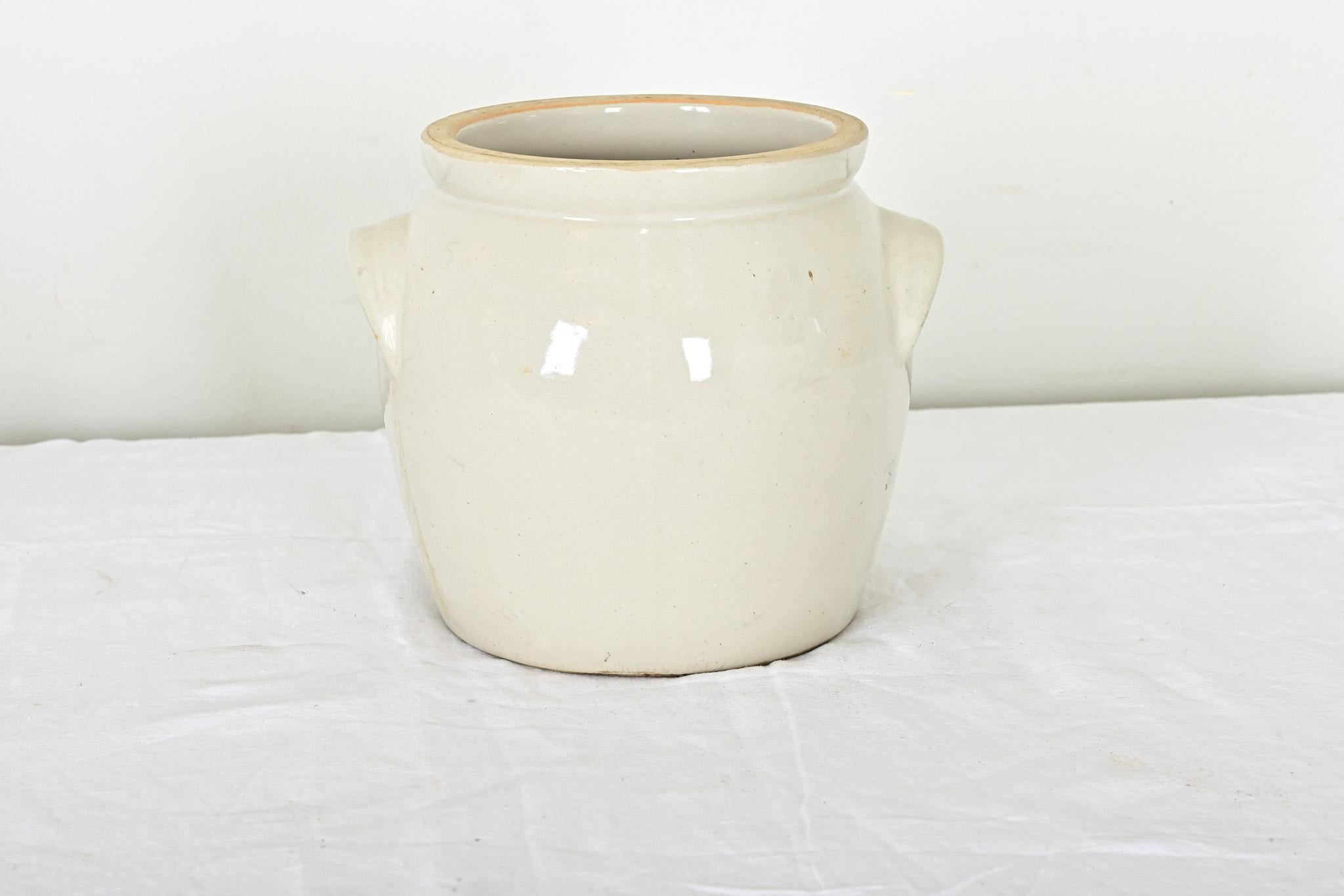 French Provincial 19th century ecru-glazed stoneware two-handled crock or storage jar. This charming vessel would bring farmhouse authenticity to the modern kitchen with its smooth, undecorated form and refined construction. Solid and sturdy for