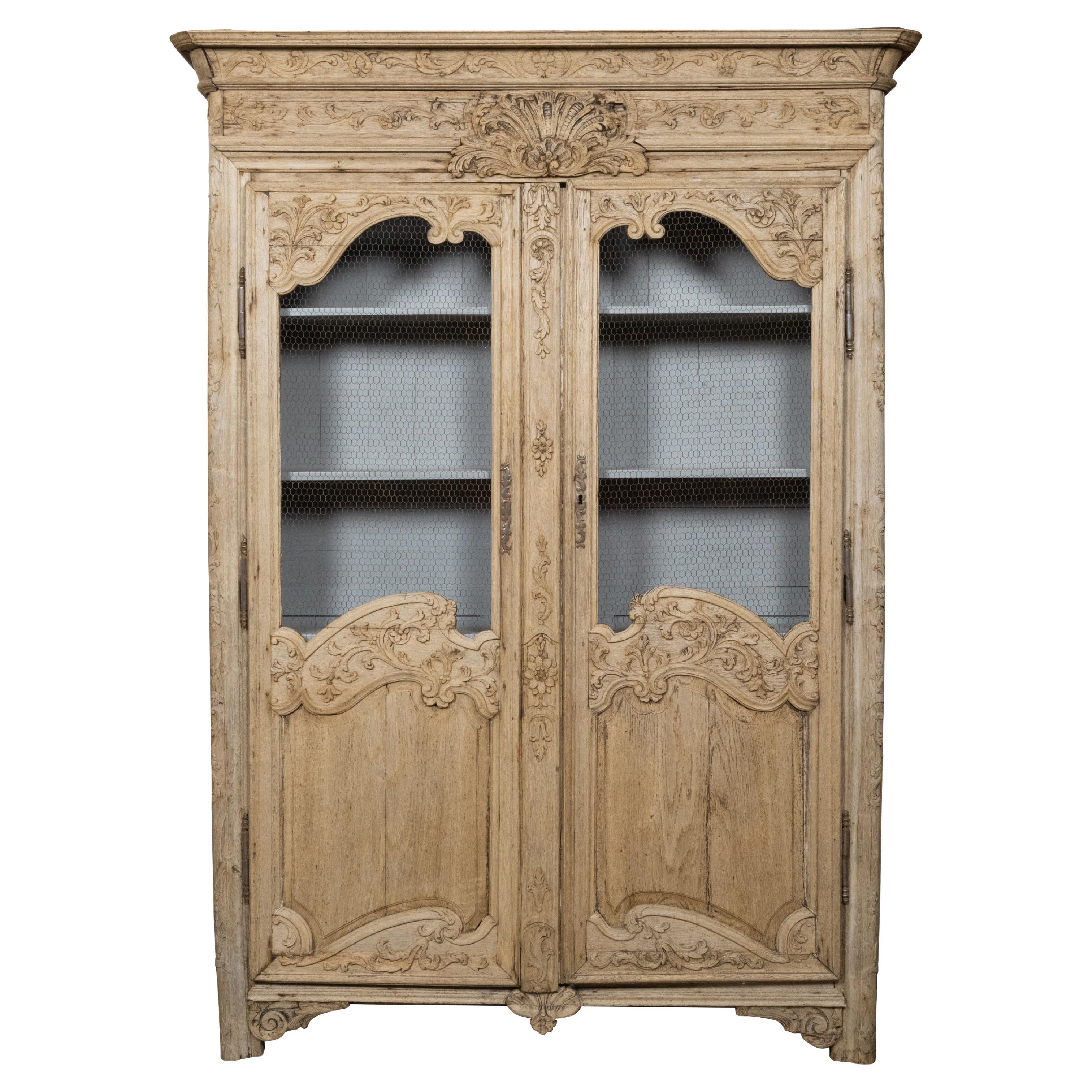 French 19th Century Stripped Wood Bookcase with Carved Scrolling Motifs