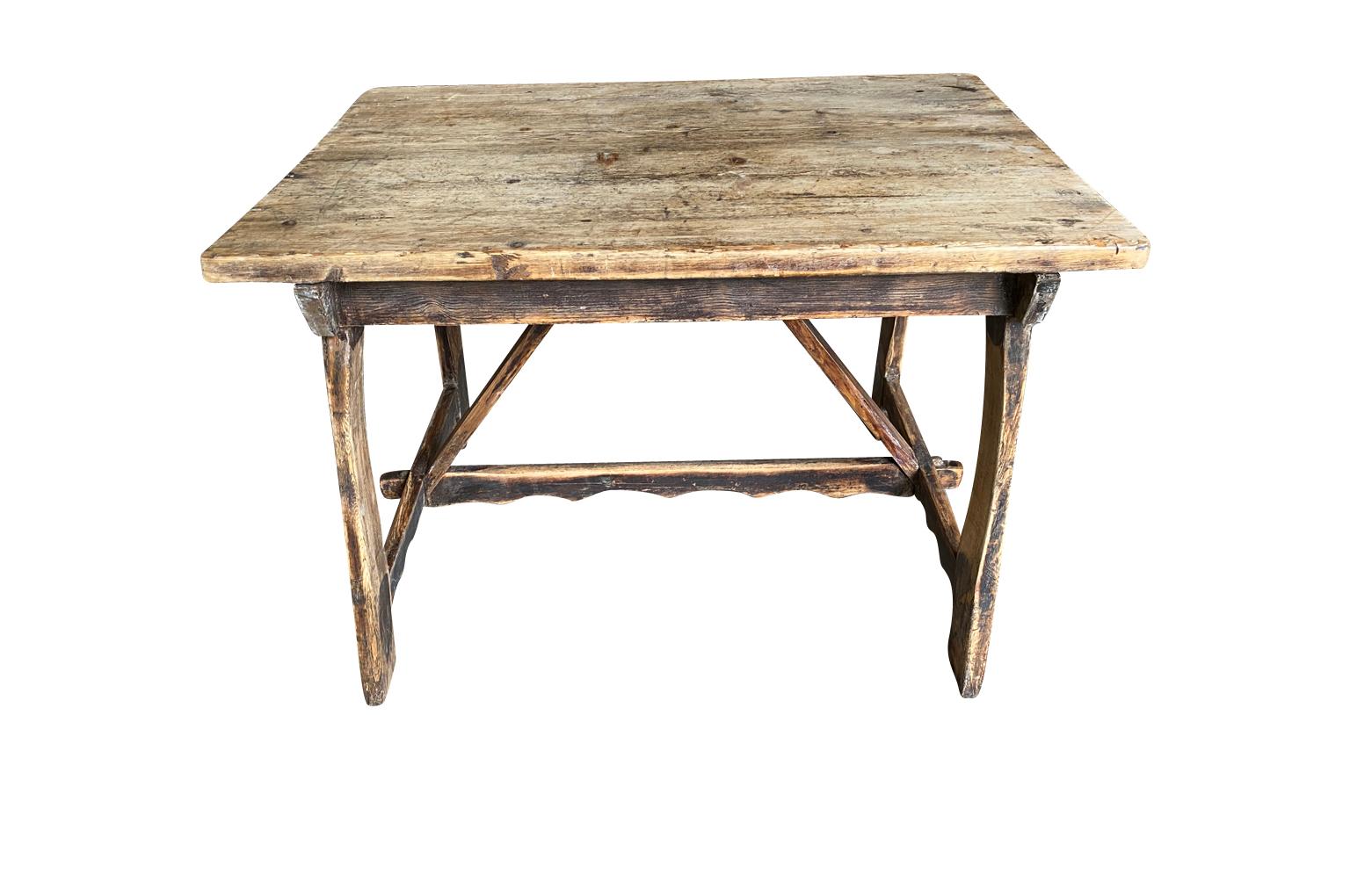 A primitive later 19th century Farm Table soundly from the South of France constructed from well patina'd pine with charming sculpted stretchers.  Wonderful as a writing table.