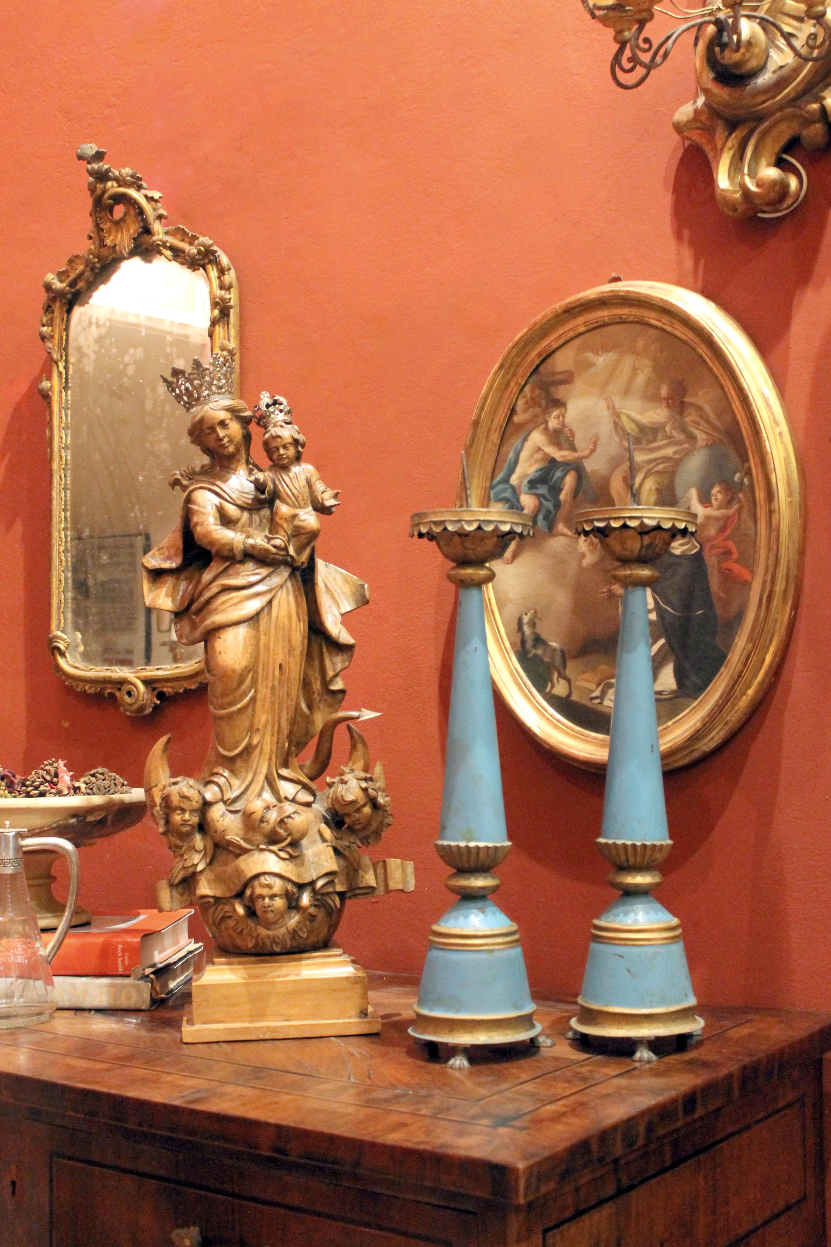 This pair of tall French 19th century blue painted tole and parcel gilt tin pricket candlesticks feature an elegant neoclassical Louis XVI shape. 
Each candleholder with inverted scalloped drip pan enriched by a foliate motif and with pricket at the