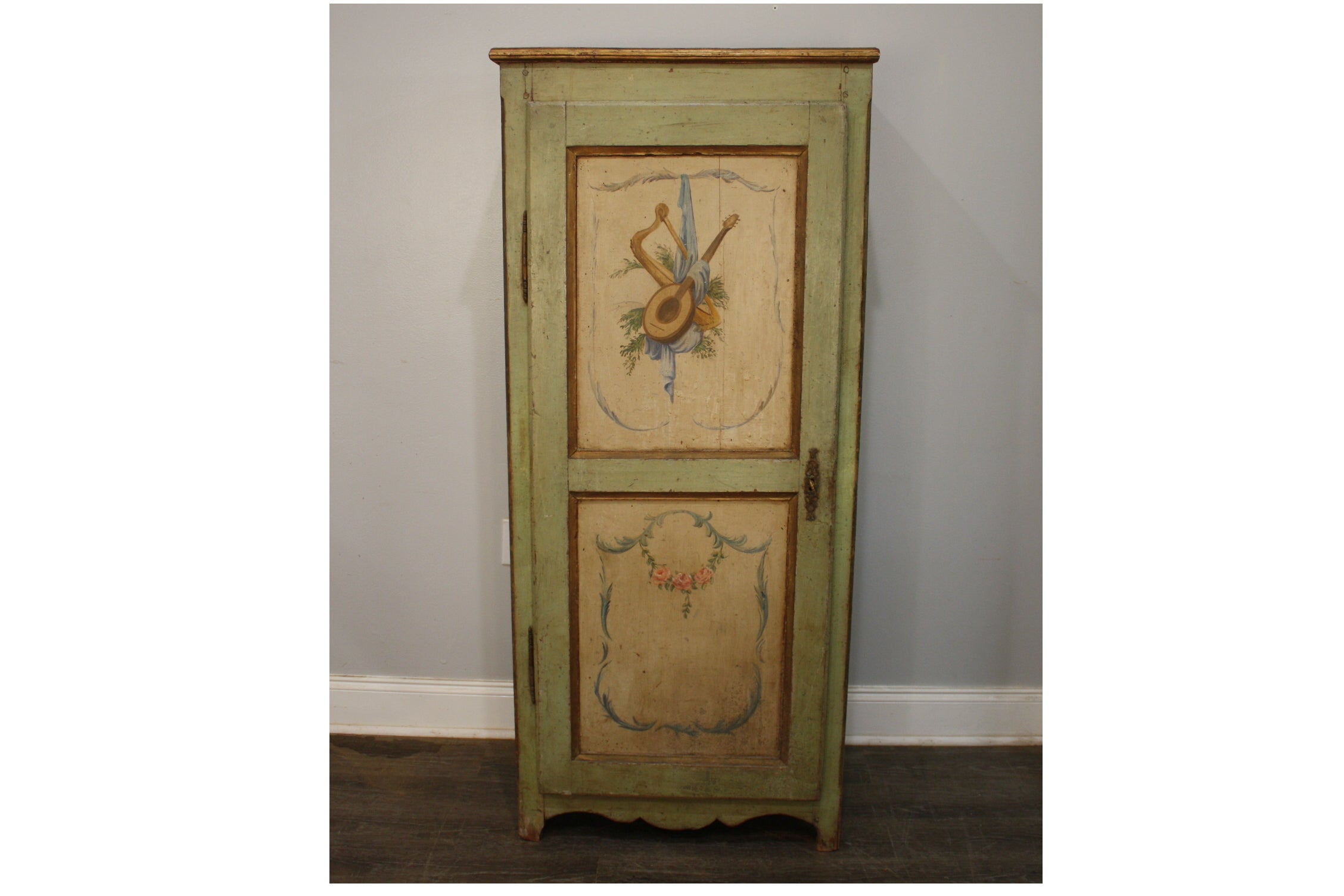 This Tall Cabinet called Bonnetiere has its original painted in the style of Louis XVI with the attribute of music. 