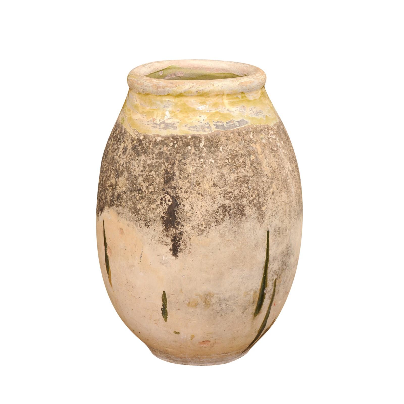 A French Provincial terracotta Biot jar from the 19th century with yellow glaze and rustic character. Elevate your space with this exquisite French 19th century glazed terracotta Biot jar that exudes rustic elegance and the timeless charm of