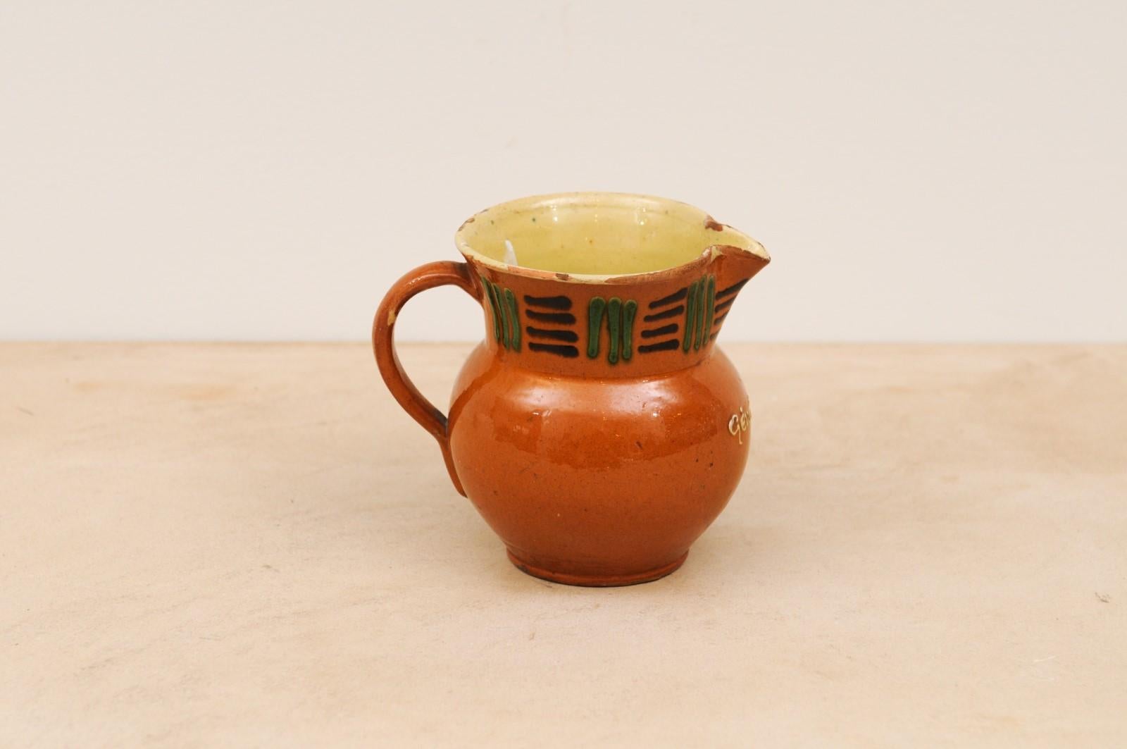 Pottery French 19th Century Terracotta Pitcher from Génolhac with Russet Colored Glaze For Sale