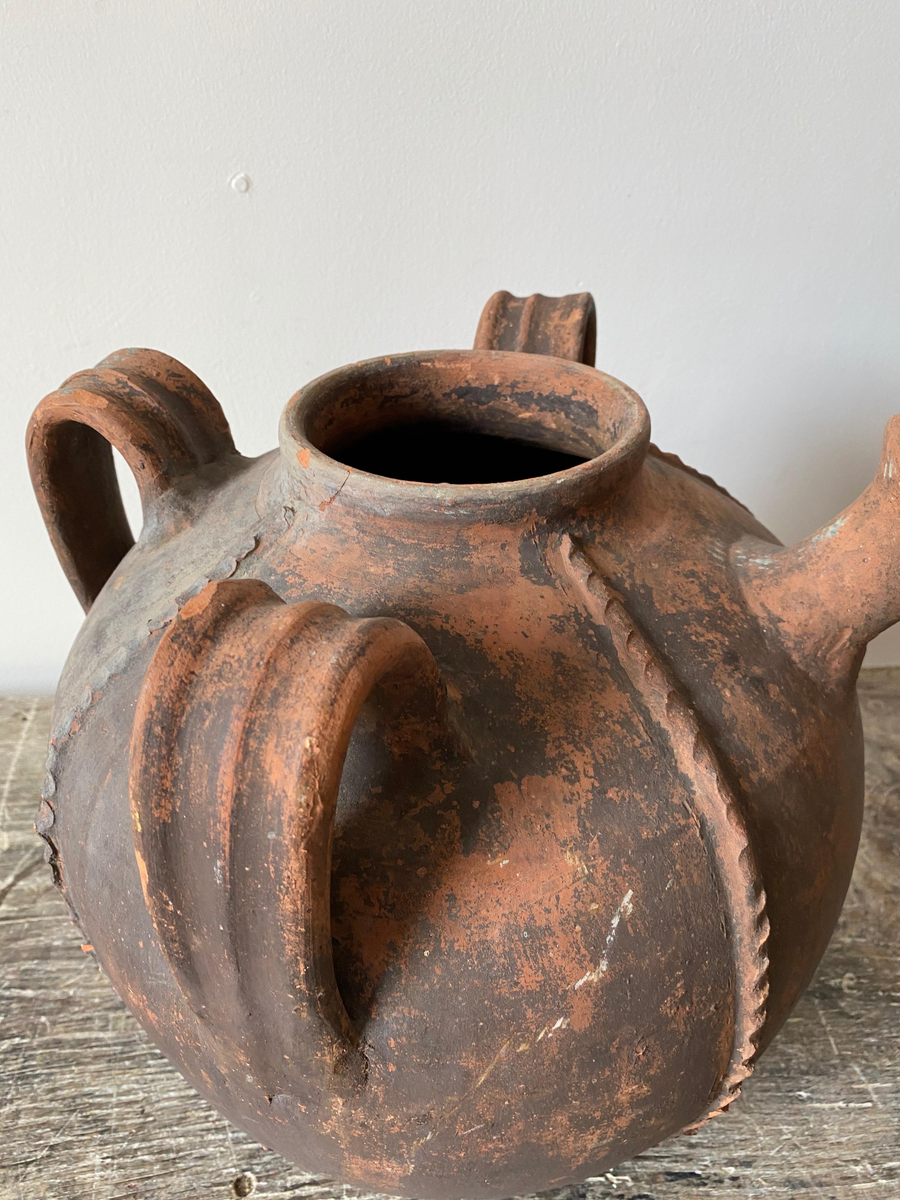 French terracotta walnut oil pot, hadn't pinched decoration, triple handle with glorious pouring spout.