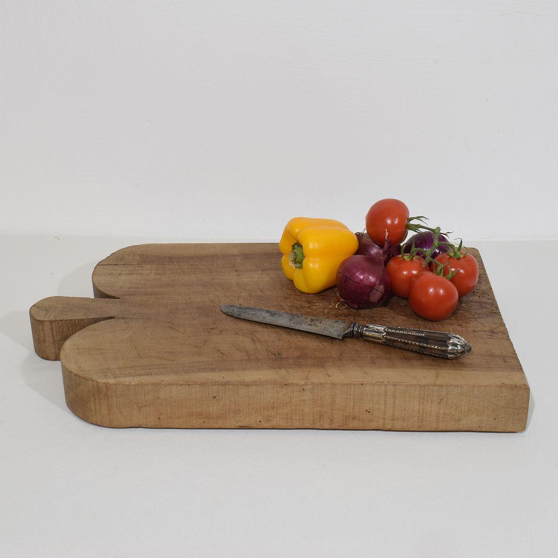Unique and thick wooden chopping-cutting board with a beautiful form. Great statement on your countertop,
France, circa 1850-1900
Weathered. If needed items were treated against woodworm.