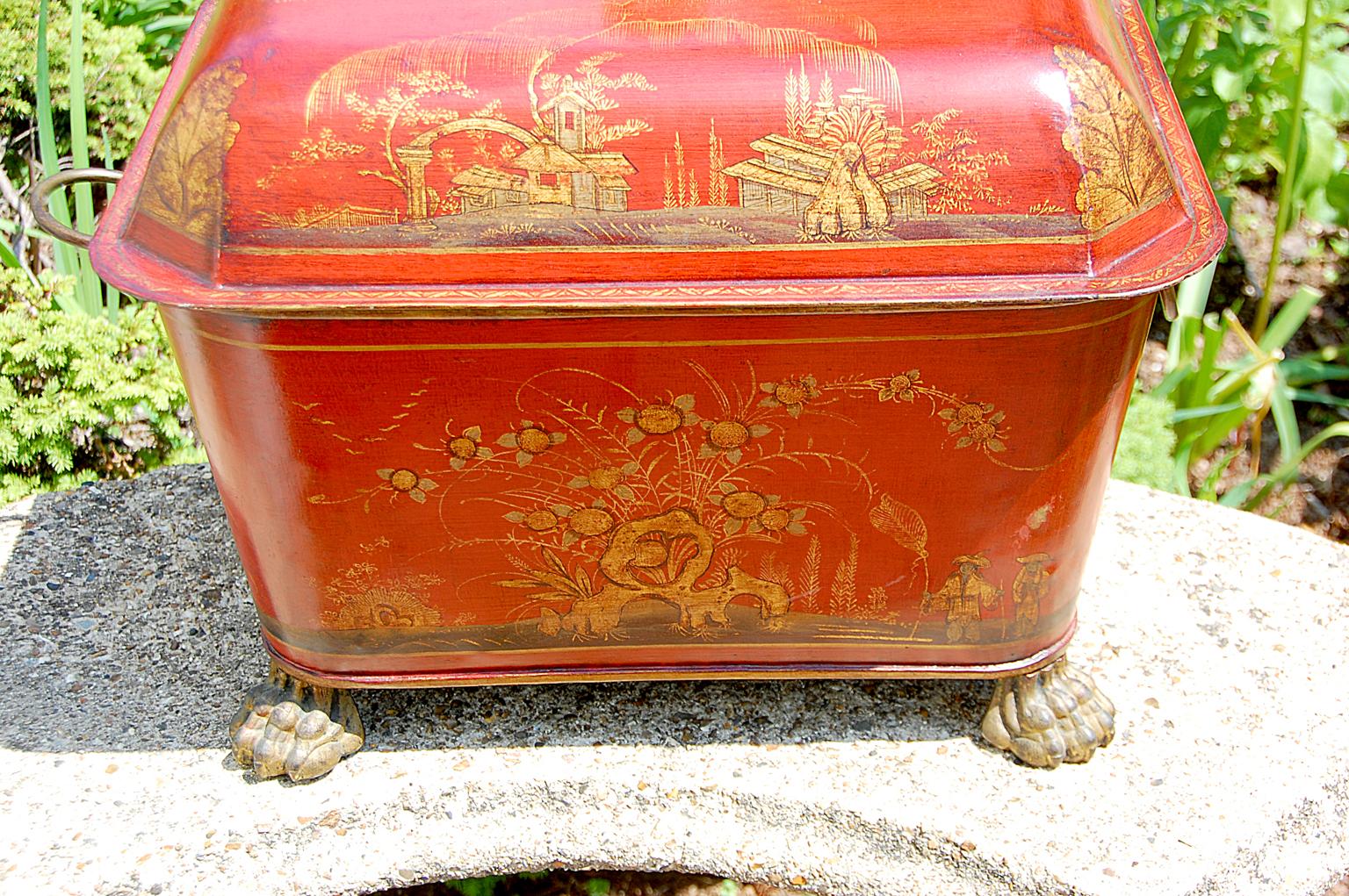 French 19th century chinoiserie decorated tole lidded coal bin on cast iron and gilded paw feet and cast and gilded loop side handles. The decoration and interior black paint is probably 20th century.