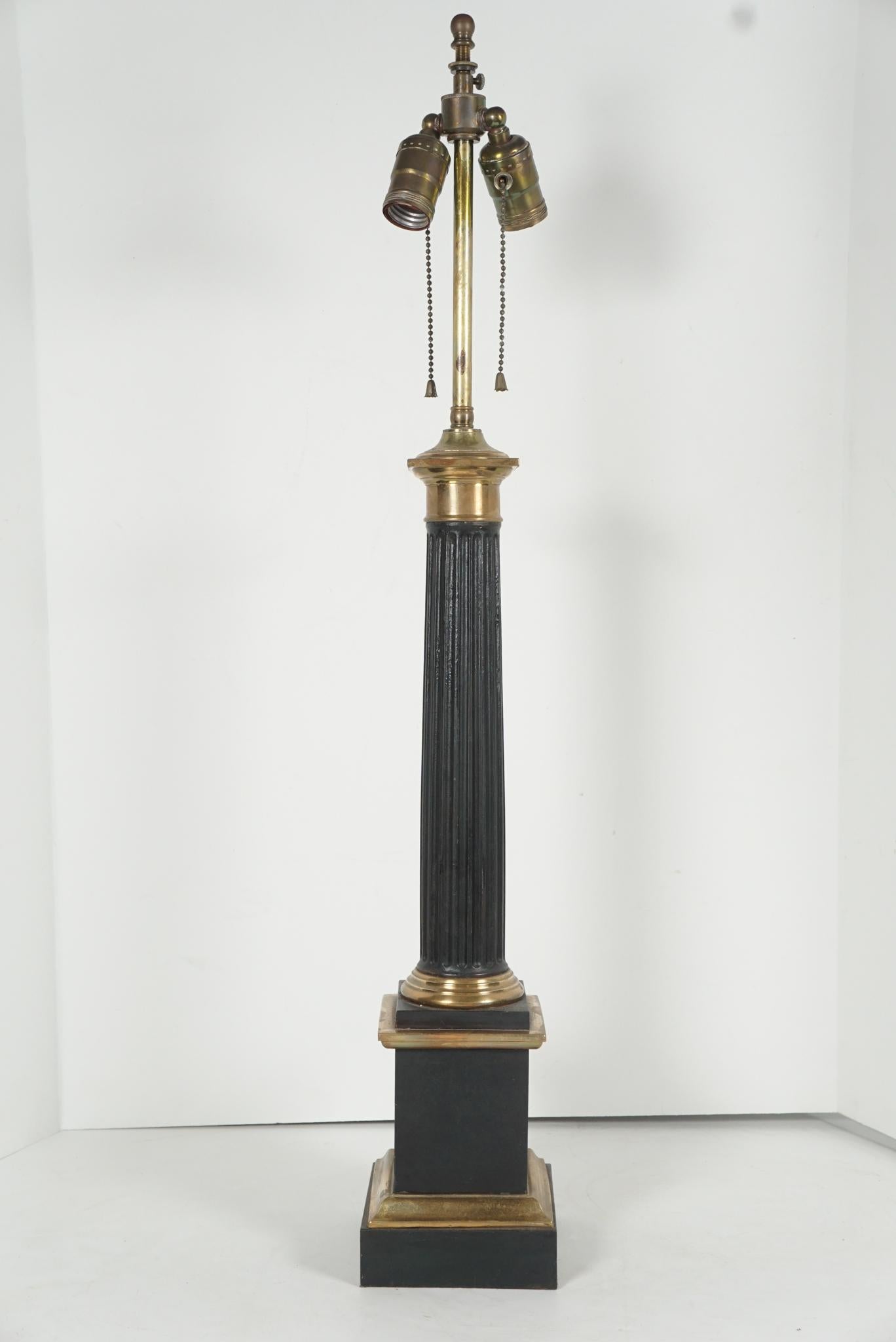 This fine classical carcel lamp would originally have had a burner and glass shade but now is fitted for electricity and will require a tole or cloth shade. 
Designed as a classical fluted column resting on a block base and plinth the lamp is made
