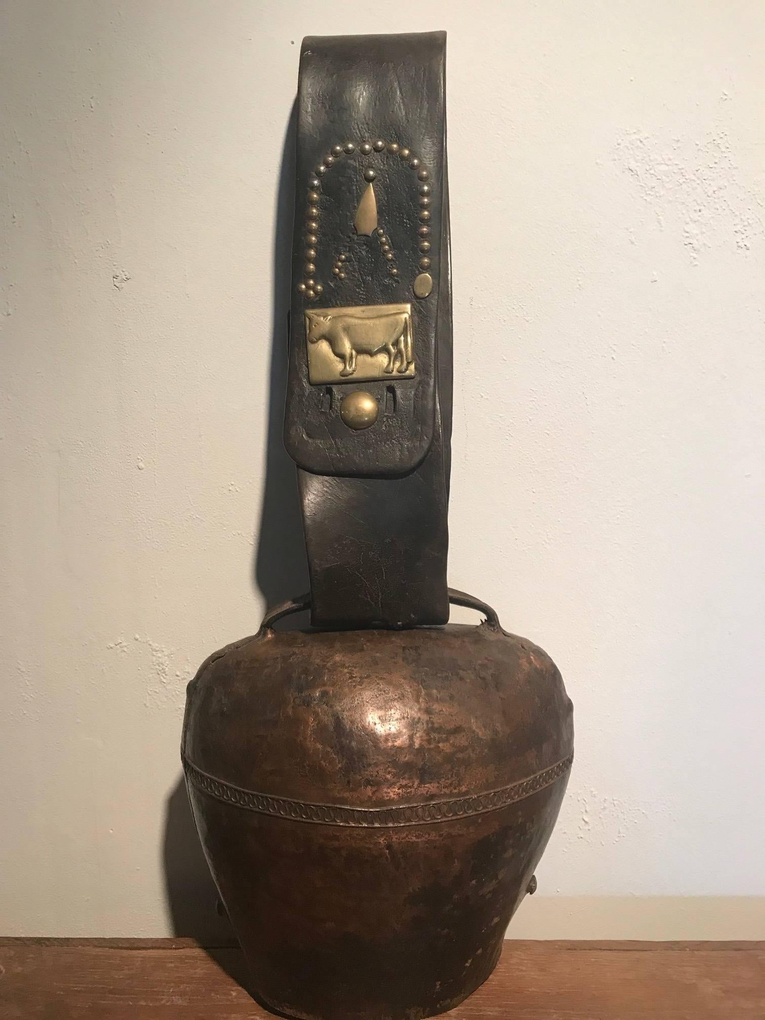 A wonderful later 19th century Toro Bell - Bull Bell from the southwest of France. Wonderfully crafted from patinated metal and a beautifully patina'd leather strap adorned with a handsome brass bull. A terrific decorative piece for a casual living