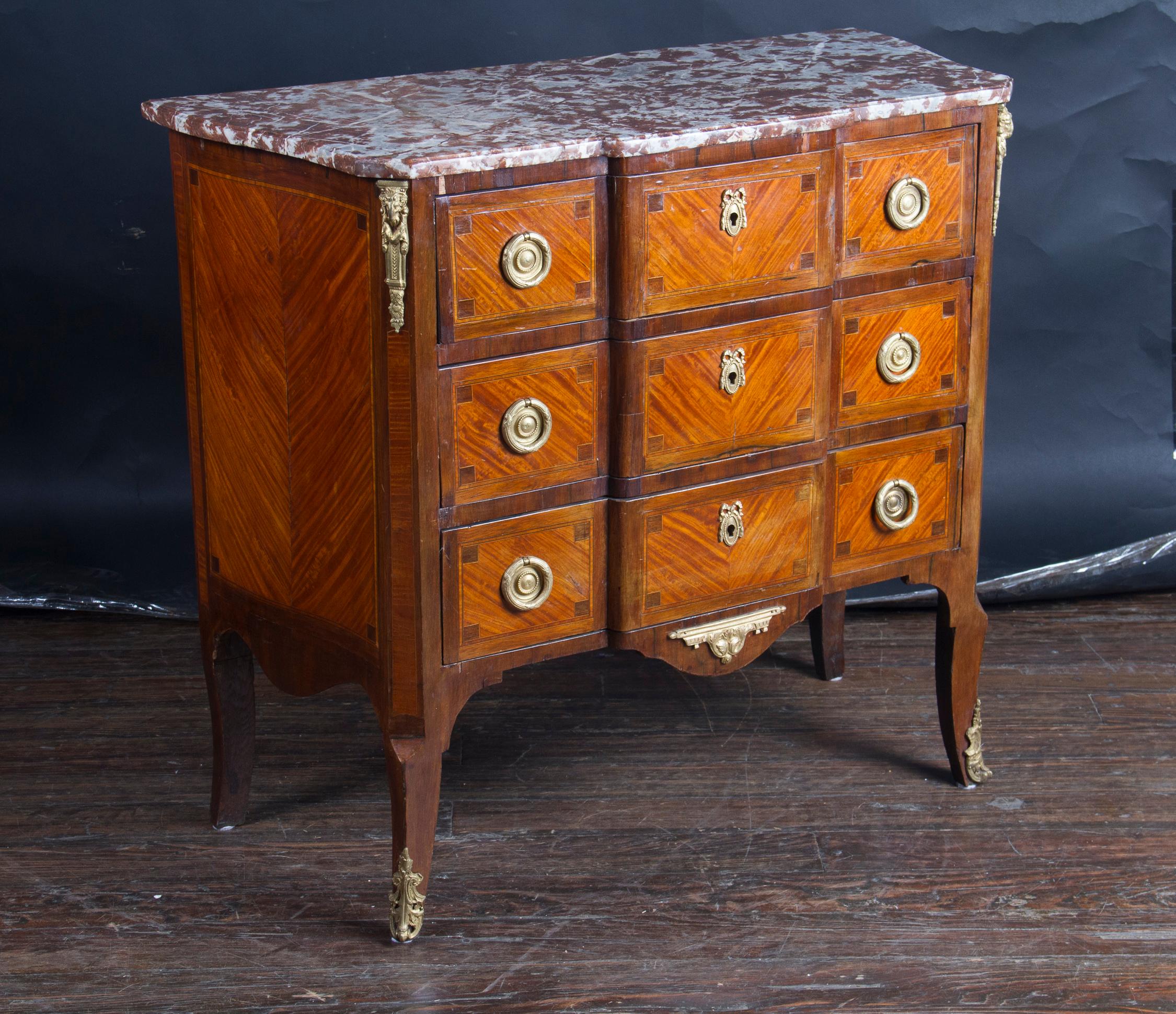 French 18th century Louis XV Bombé two drawer commode with marble top, bronze escutcheon and mounts.  The drawer fronts are  heavily inlaid with marquetry design of violins, drums, horns, sheet music, centered with pair of quivers with arrows, and