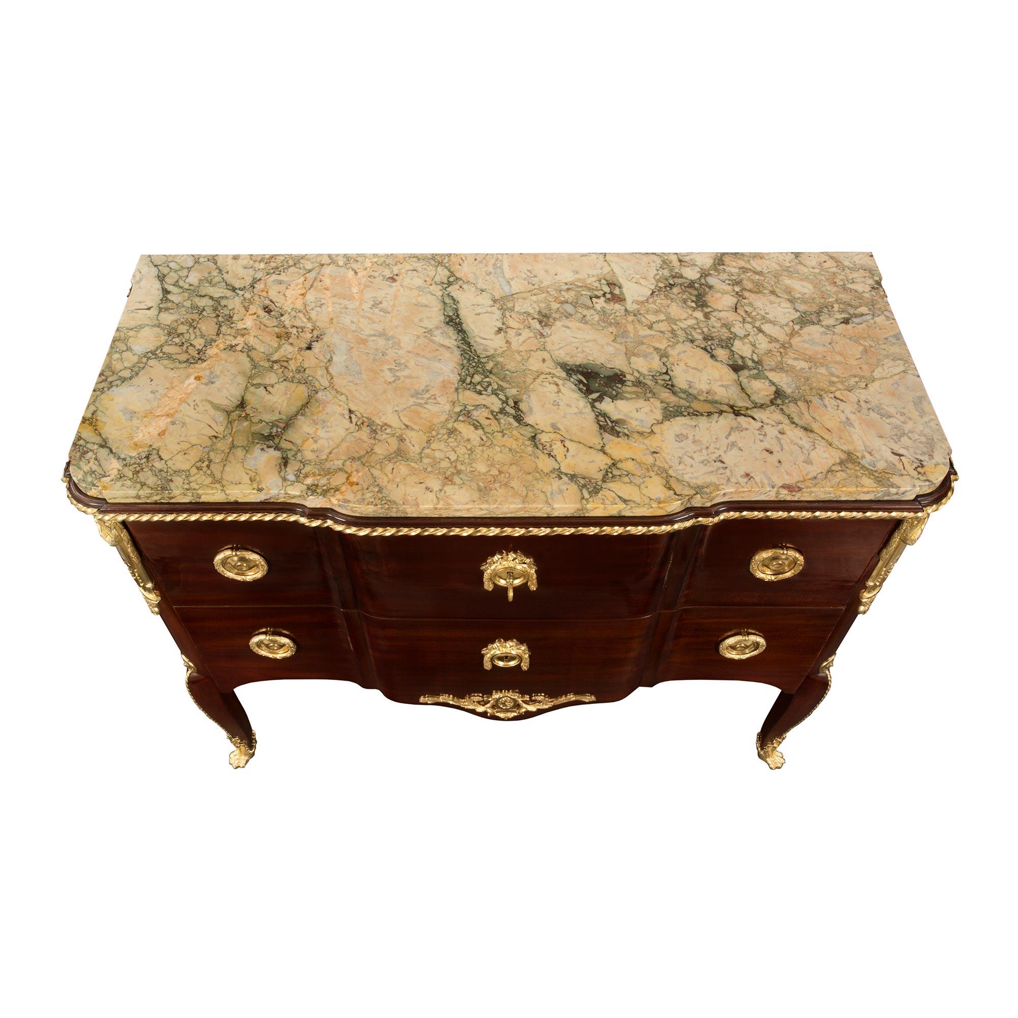 An extremely elegant and high quality French 19th century Transitional style mahogany, marble and ormolu two-drawer chest. The chest is raised by handsome cabriole legs with striking wraparound lion paw designed ormolu sabots with an acanthus leaf.