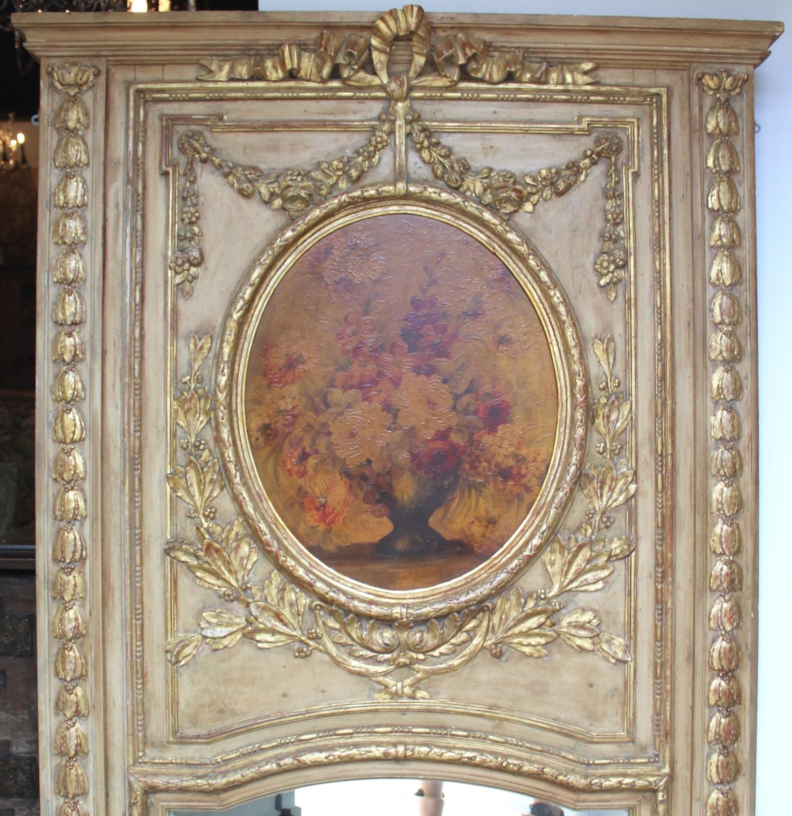 Elegant large 19th century carved wood, gilt and painted trumeau mirror. With floral painting. Silvered mirror. Very good condition. 