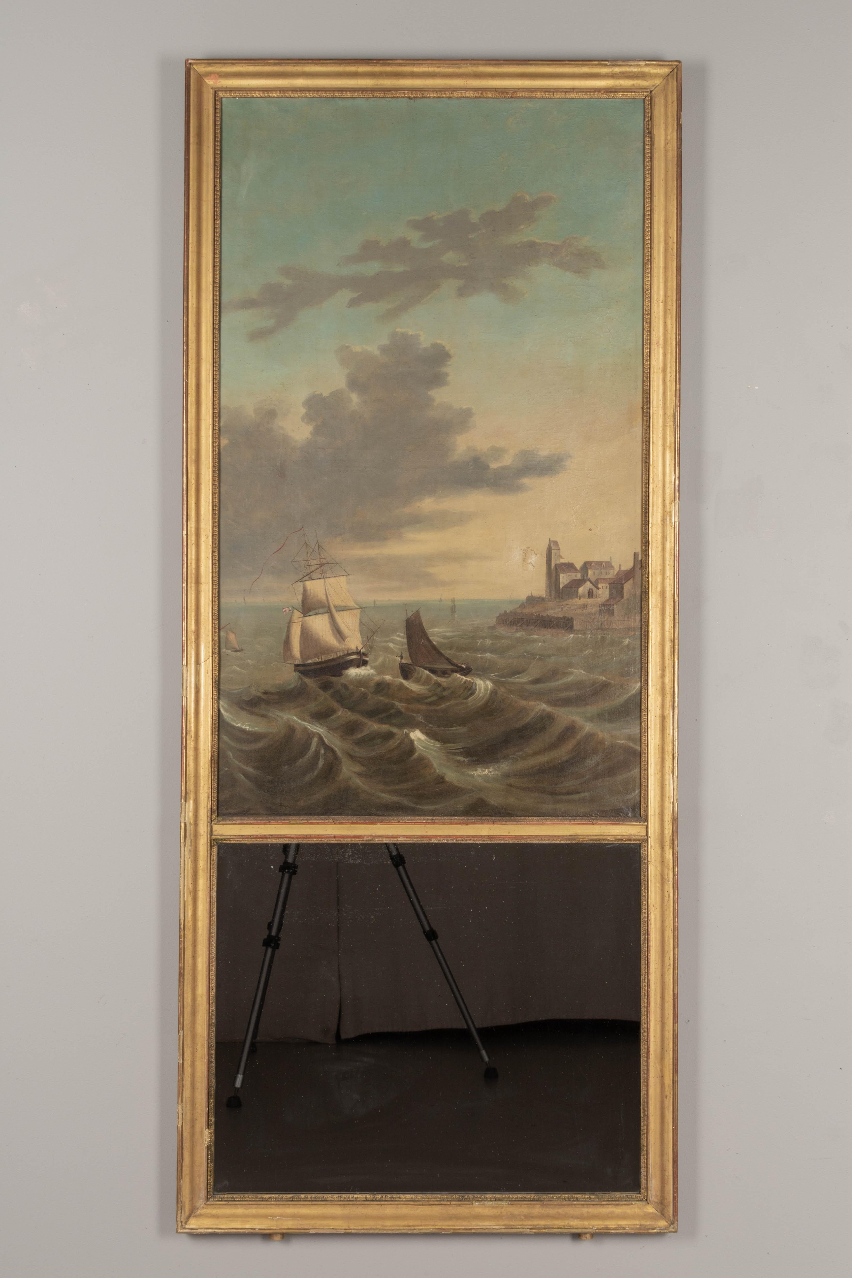 An early 19th century French Louis XV style trumeau mirror with a large oil painting depicting a seascape with ships on a stormy coast. Canvas has an old repaired tear and was relined at some point. Giltwood frame has several pieces of missing trim.