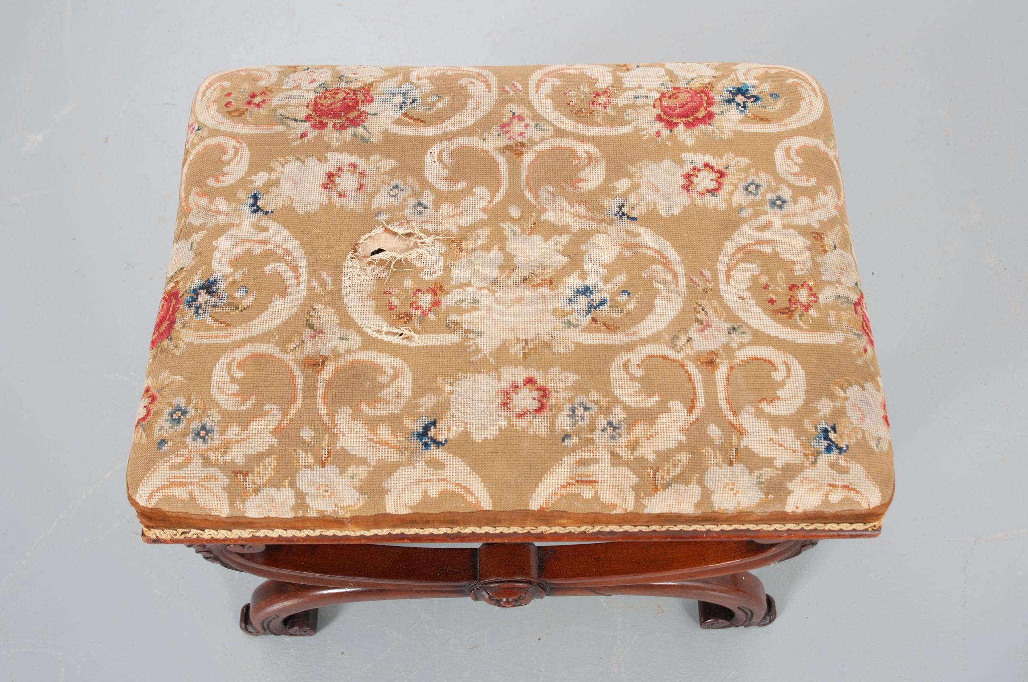 A sensational 19th century French carved walnut stool with a gorgeous needlepoint tapestry seat. Incorporating elements of Louis XVI, the shaped X-frame base is attractive and is reinforced with an expertly turned walnut stretcher. The antique