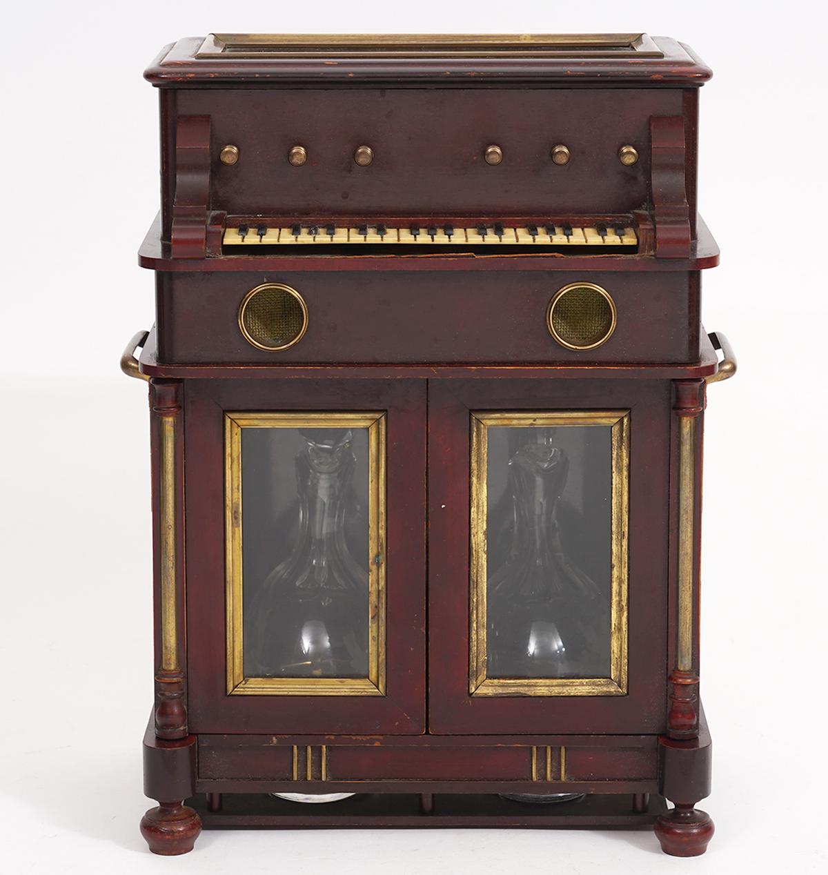 This rare and outstanding upright piano design tantalus or 'cave à liqueur' dating to around 1890 provides both liqueur and music. Simply press a button and one of two delightful melodies from the hidden music box begins to play, causing the piano's
