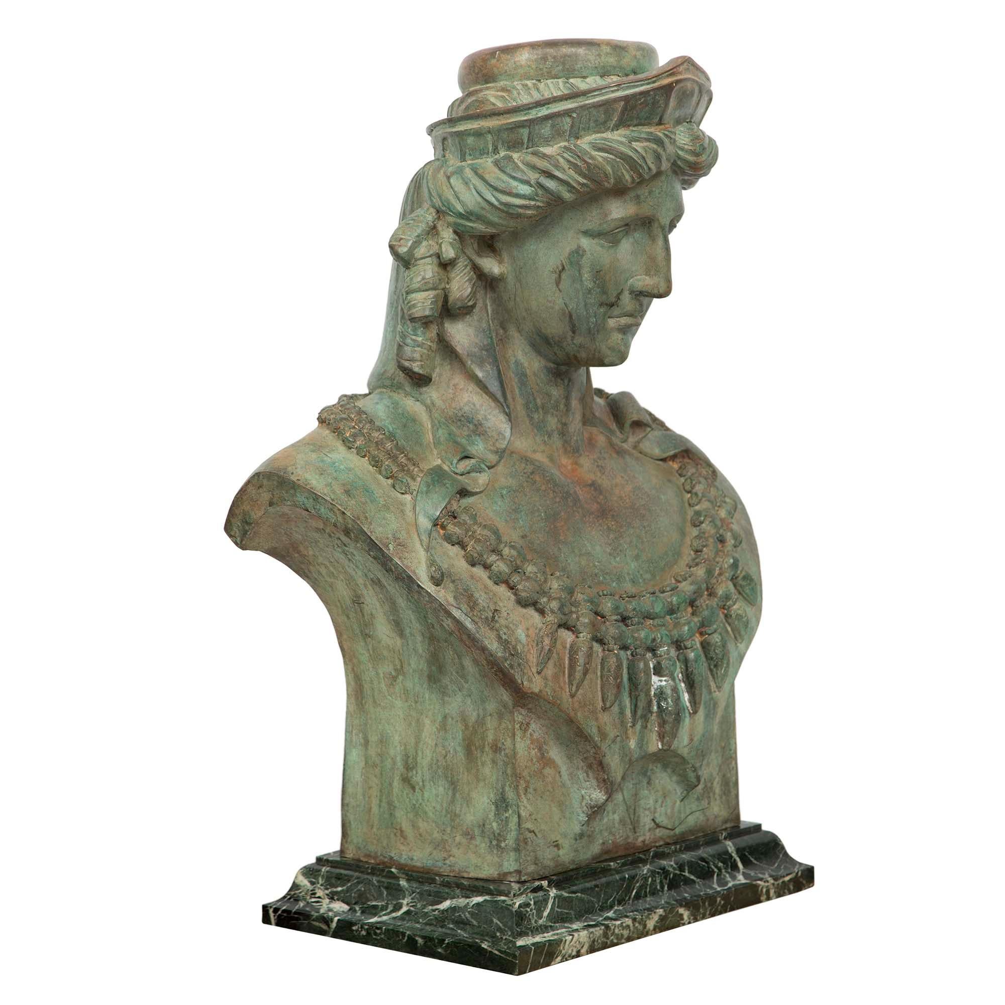 A stunning and large-scale French 19th century Verdigris patinated bronze statue of Juno. Juno is raised by a rectangular mottled Vert de Patricia marble pedestal. The bronze statue with exceptional patina throughout depicts Juno wearing a necklace