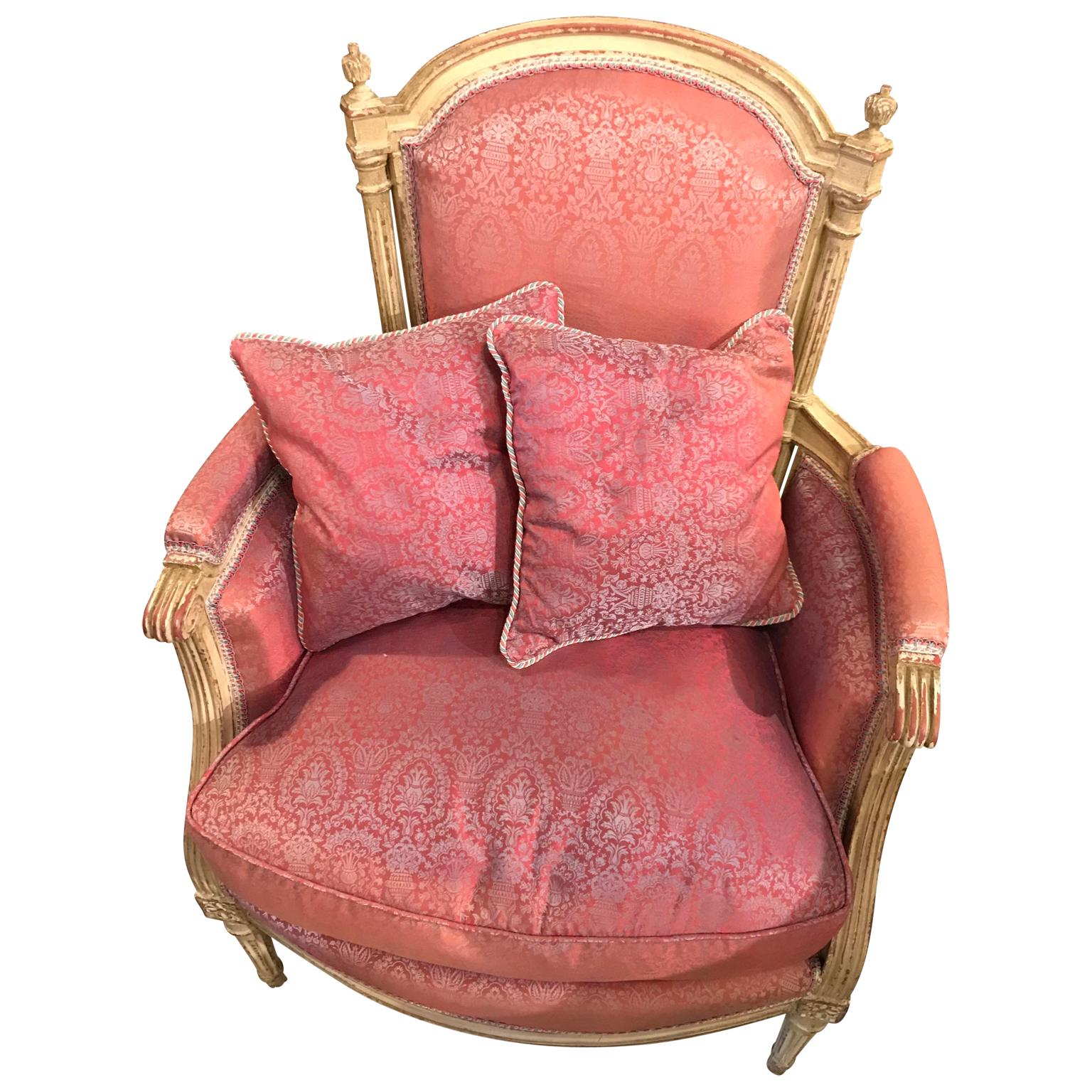 French 19th century vintage white painted bergère with pink upholstery and two additional pillows.