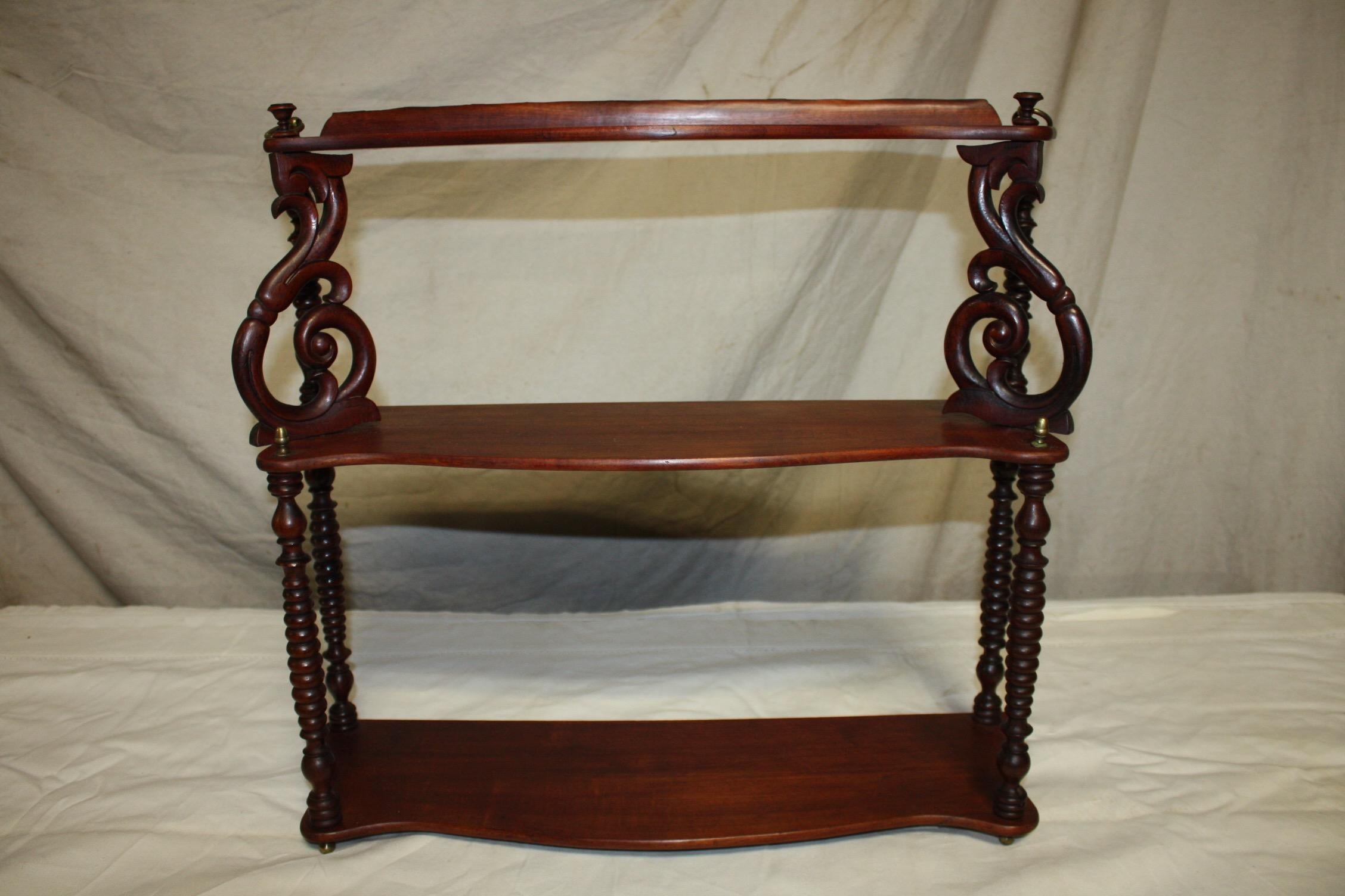 Charming piece that can be either hang on the wall or just stand up on a buffet. The shelves are in a lighter walnut color that the side columns and the top side carving pieces can be moved. Very nice piece.
