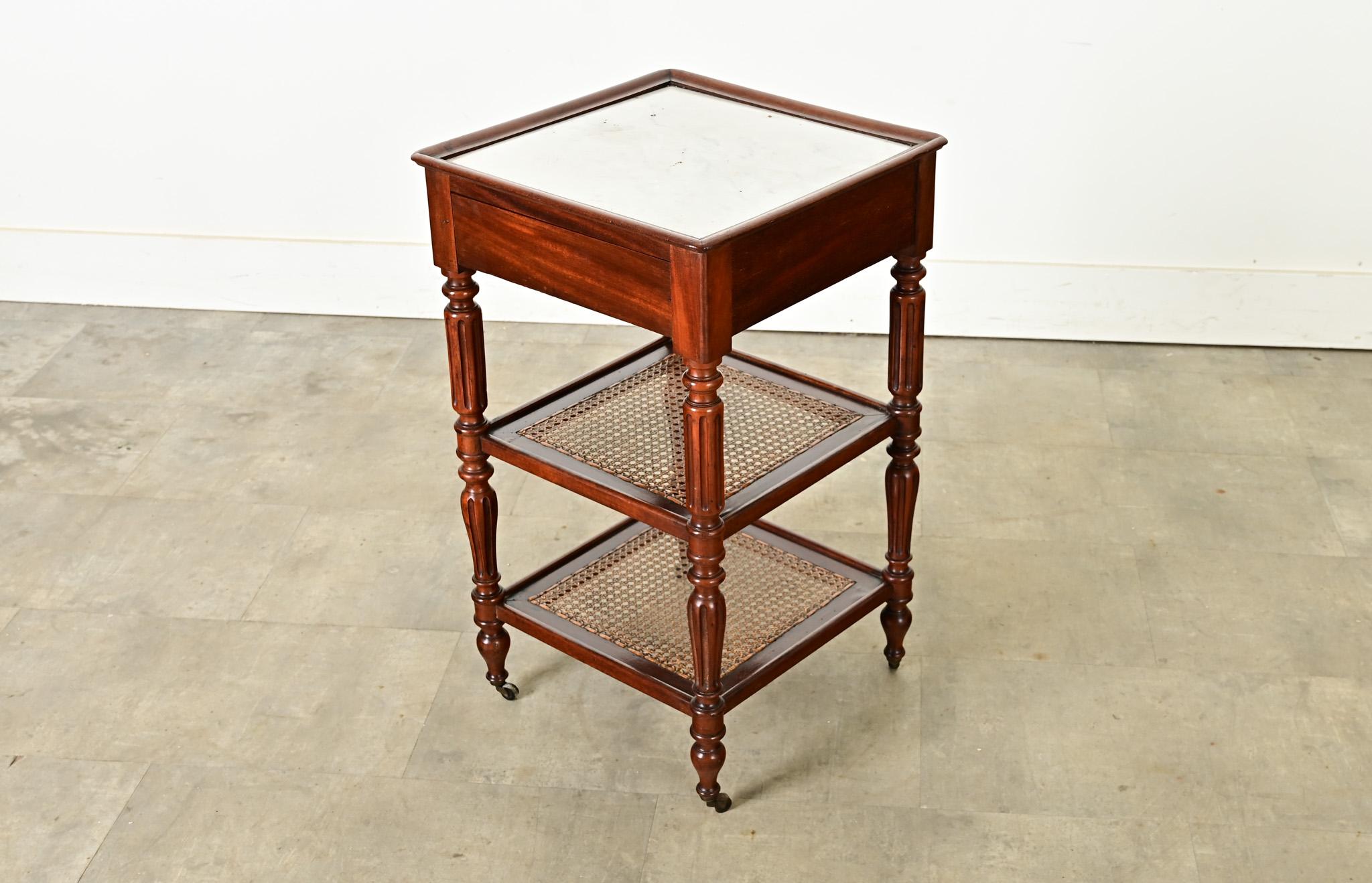 This small etagere with marble top, in walnut construction and fluted legs, from France circa 1870, is full of personality and charming details. The top tray, inset by a smooth frame, showcases the lovely white stone with minimal veining under its