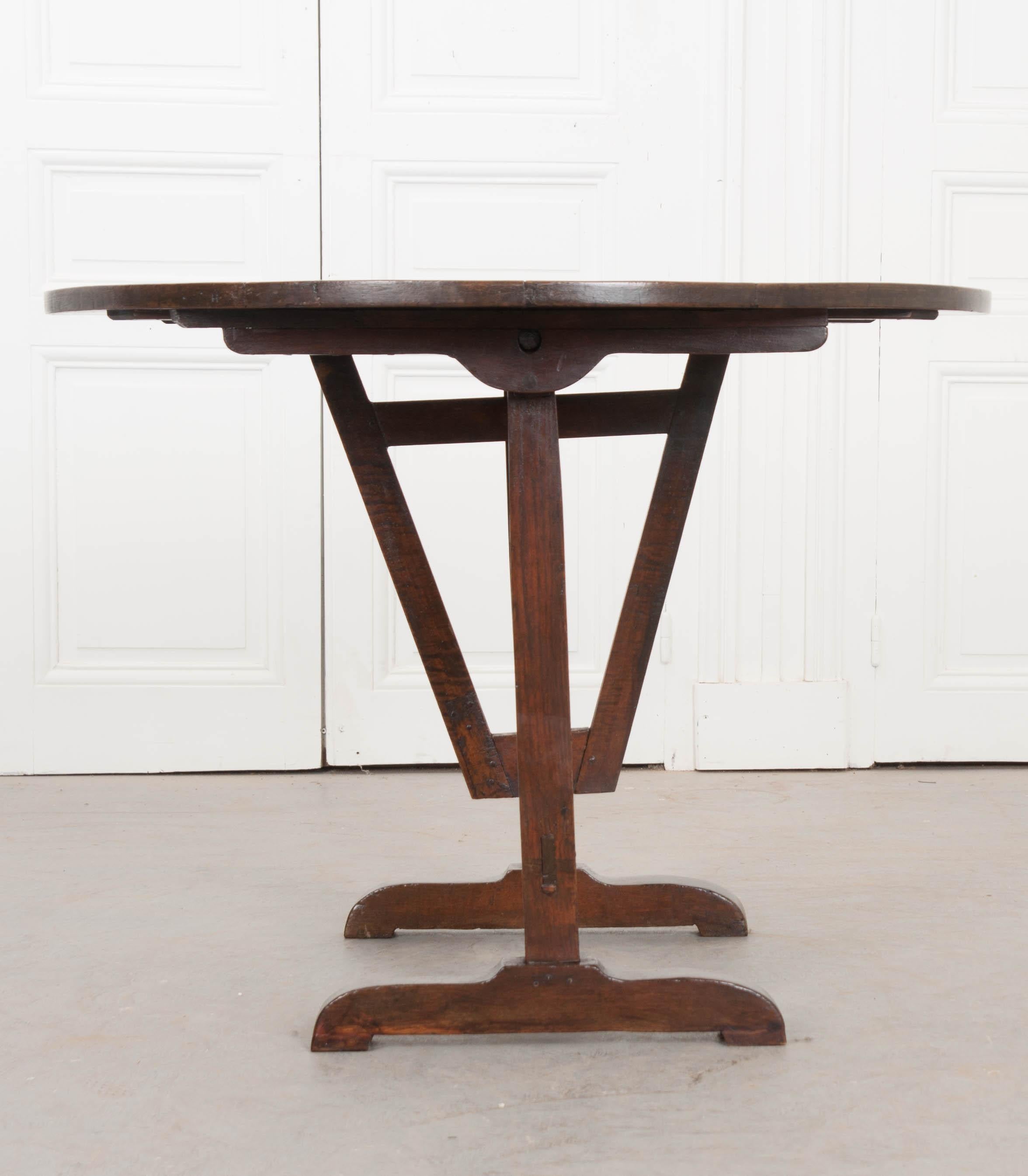Beloved by novices and connoisseurs alike, wine tasters tables are extraordinarily functional and versatile pieces of furniture. This large, solid walnut-top table is in outstanding condition and very sturdy when laid down, thanks to its cleverly