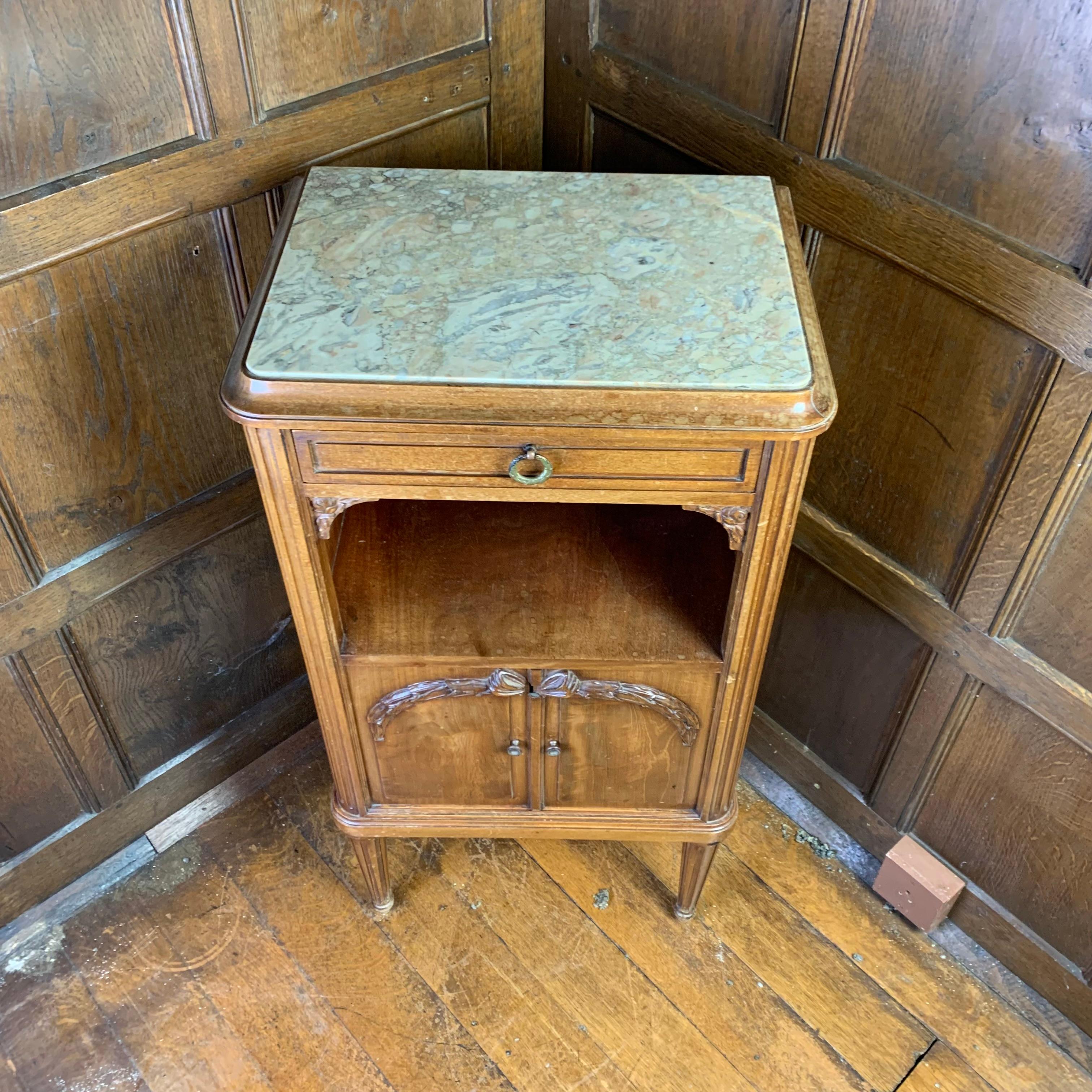 A fine quality late 19th century French walnut nightstand, the top inset with vieined white marble with concave outer mouding above a single drawer and an open shelf. Below is a two-door cupboard which is beautifully lined in marble and the whole is