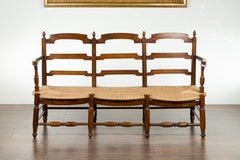 French 19th Century Walnut Bench with Open Ladder Style Back and Rush Seat