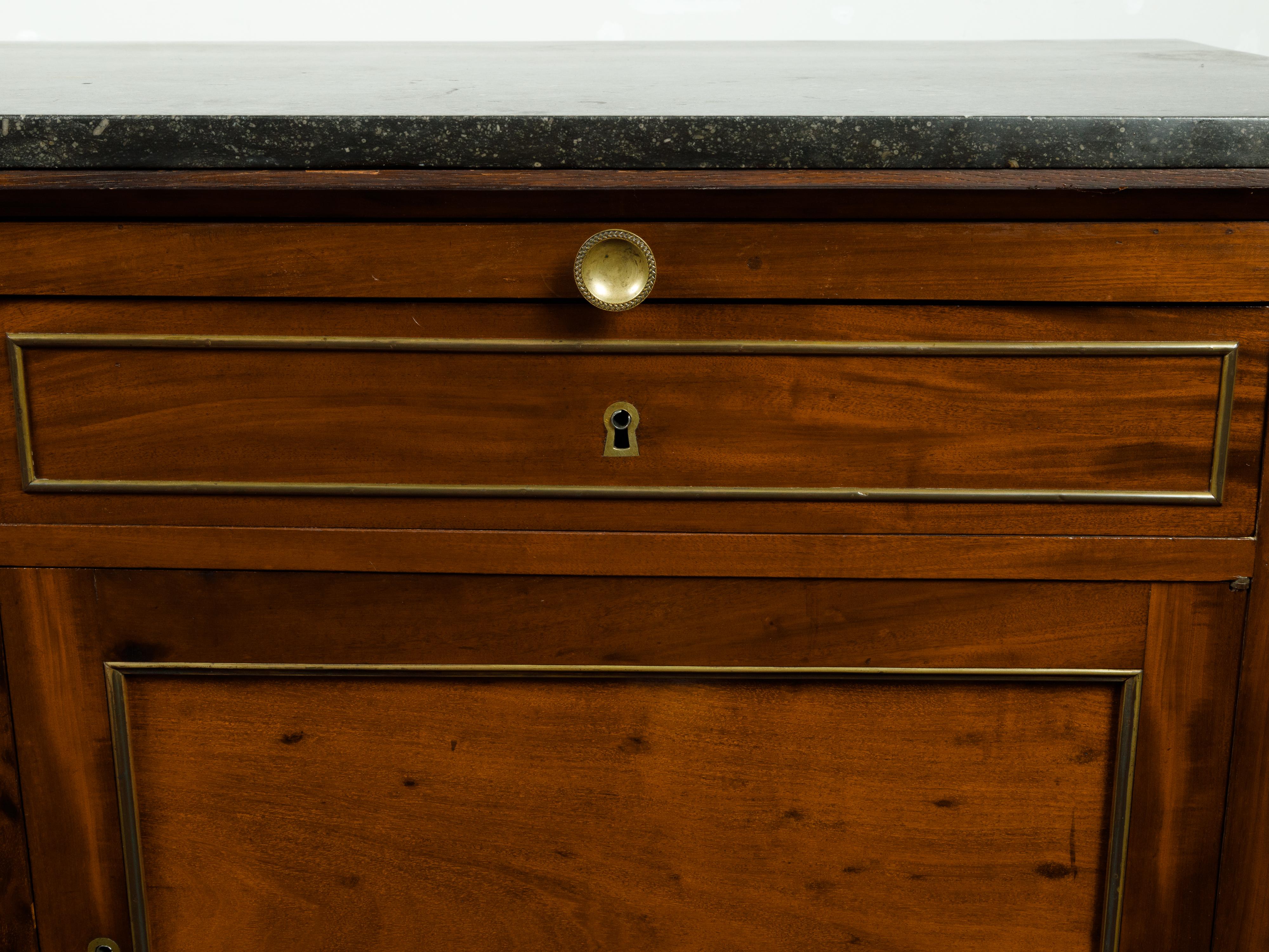 A French walnut buffet from the 19th century, with marble top, pull-out, two drawers and two doors. Created in France during the 19th century, this walnut buffet features a black marble top sitting above a pull-out drawer also fitted with marble.