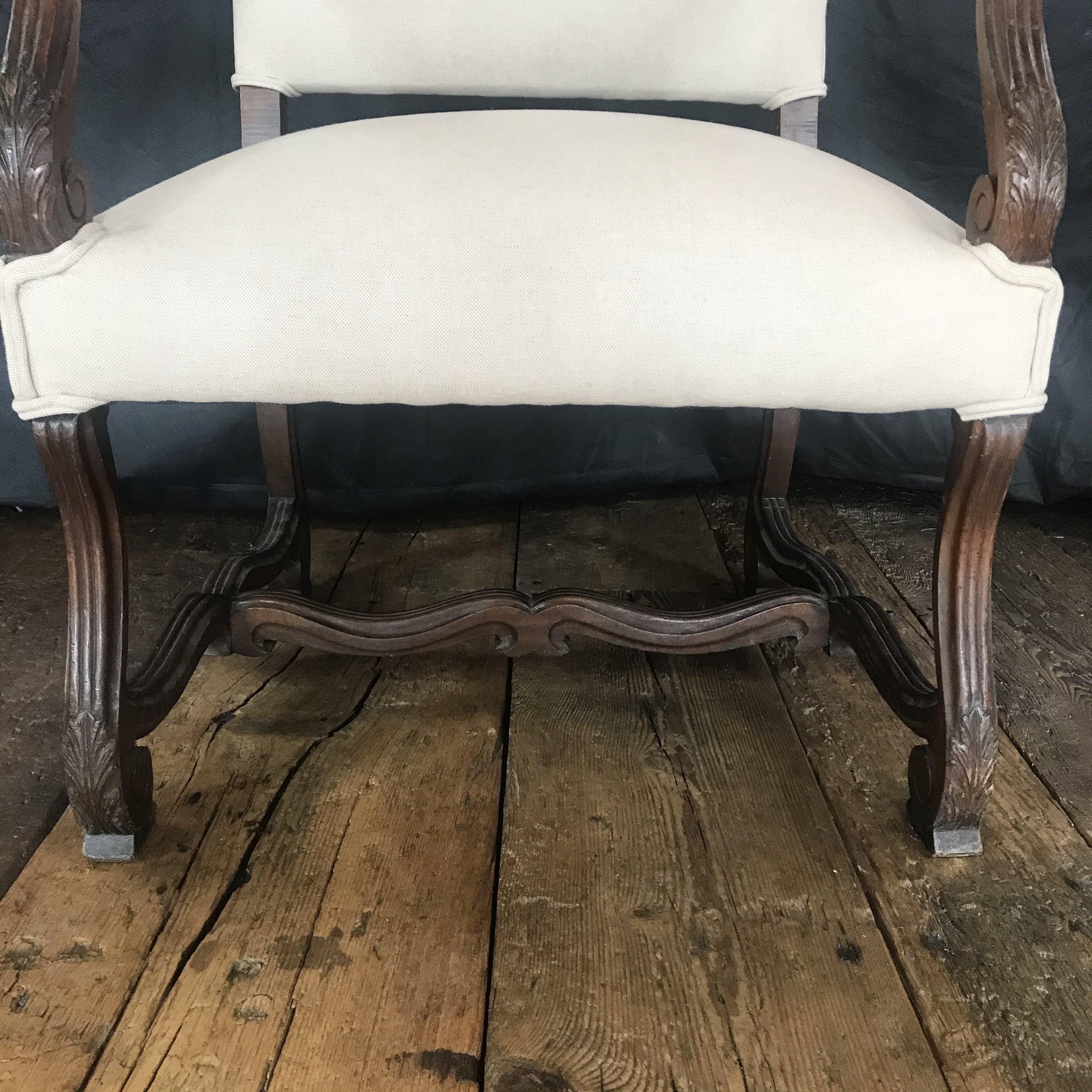 French 19th century walnut carved Louis XV armchair or head dining chair.
This gorgeous French 19th century walnut carved Louis XV armchair or head dining chair can be used in a number of settings - living room, bedroom, or, matched with another of