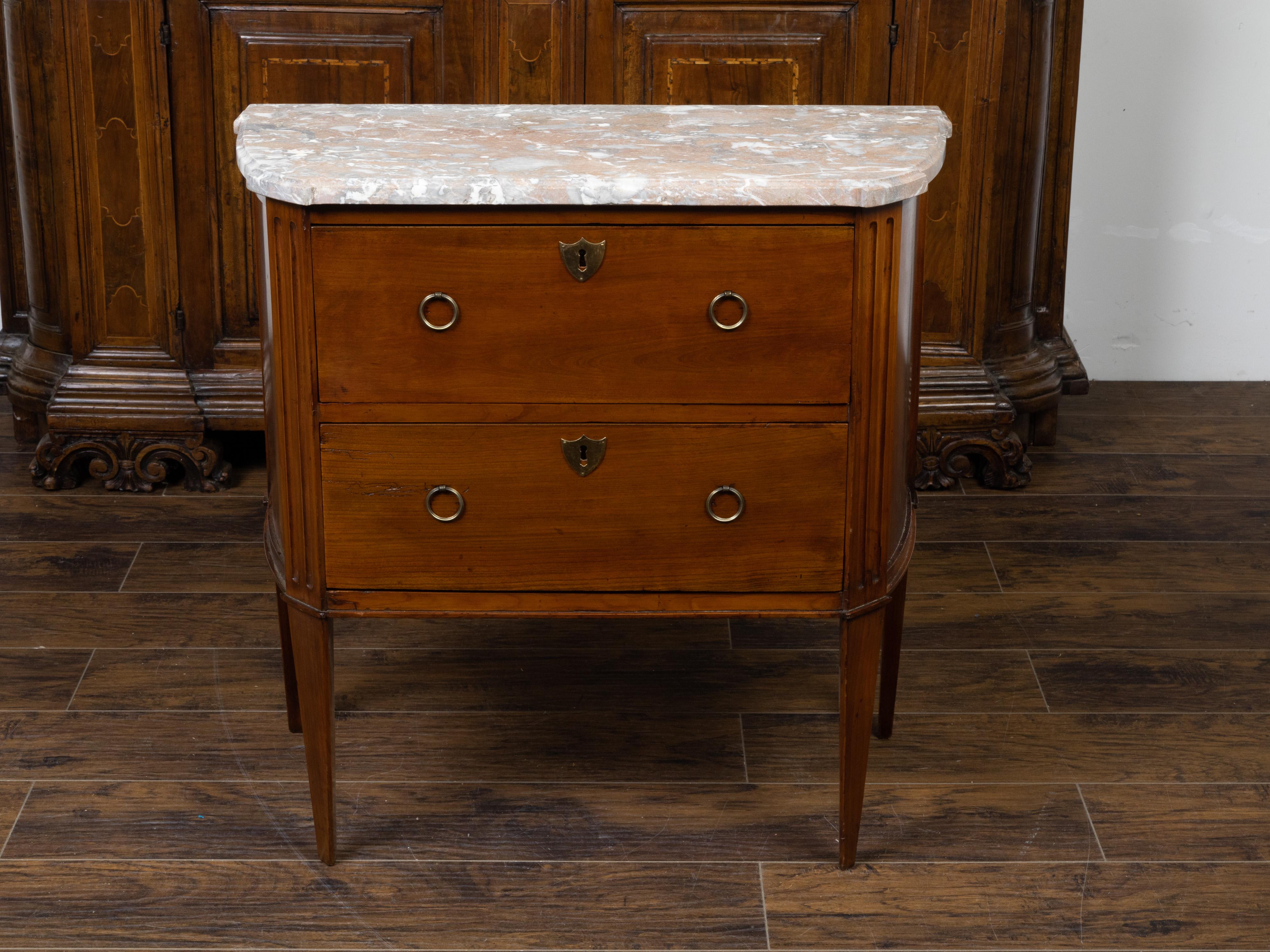 A French walnut commode from the 19th century, with variegated marble top and two drawers. Created in France during the 19th century, this walnut commode features a variegated marble top with protruding corners, sitting above two drawers fitted with