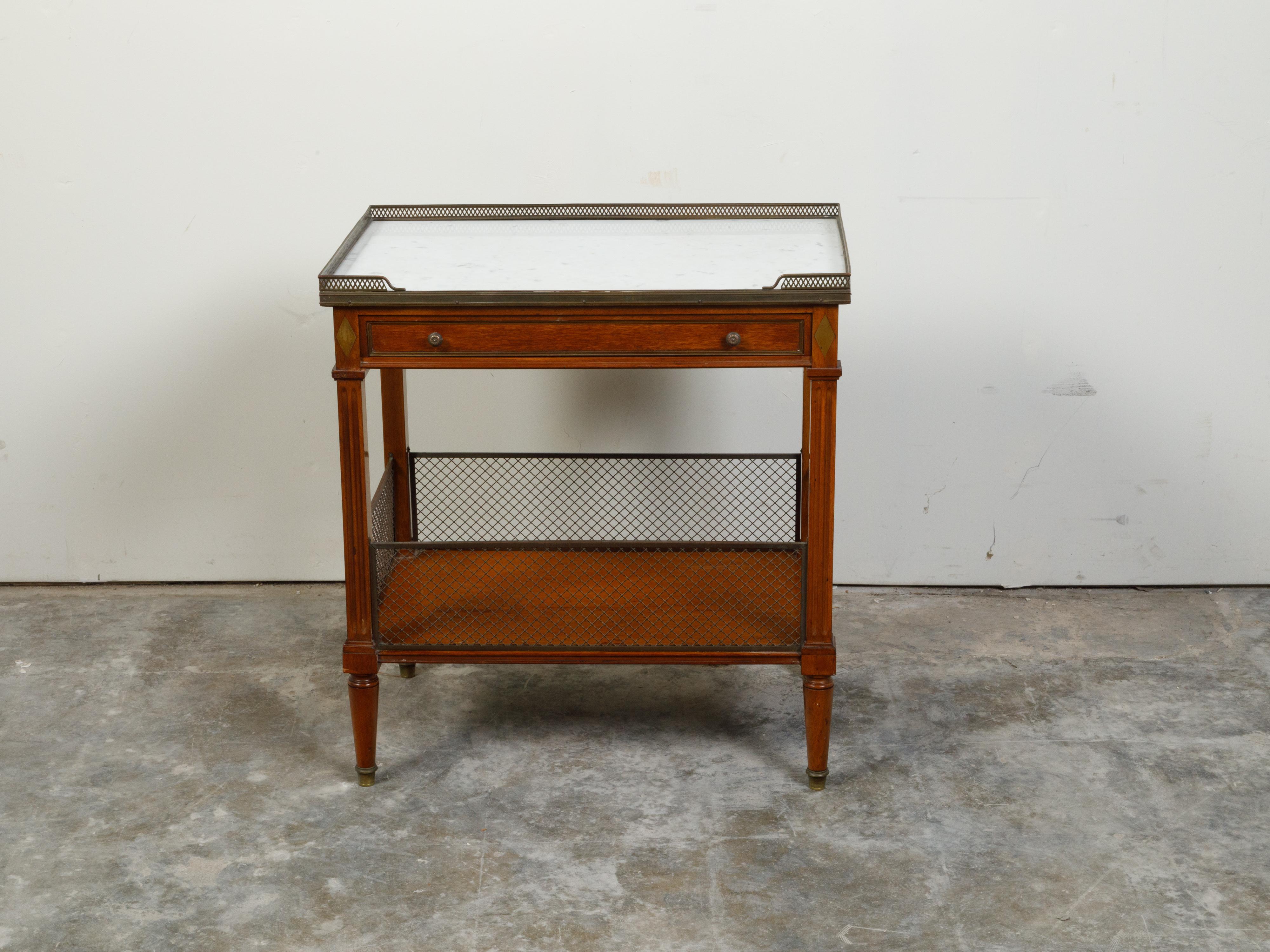 A French walnut console table from the 19th century, with white marble top, brass gallery and single drawer. Created in France during the 19th century, this console table features a rectangular white marble top with pierced three-quarter brass